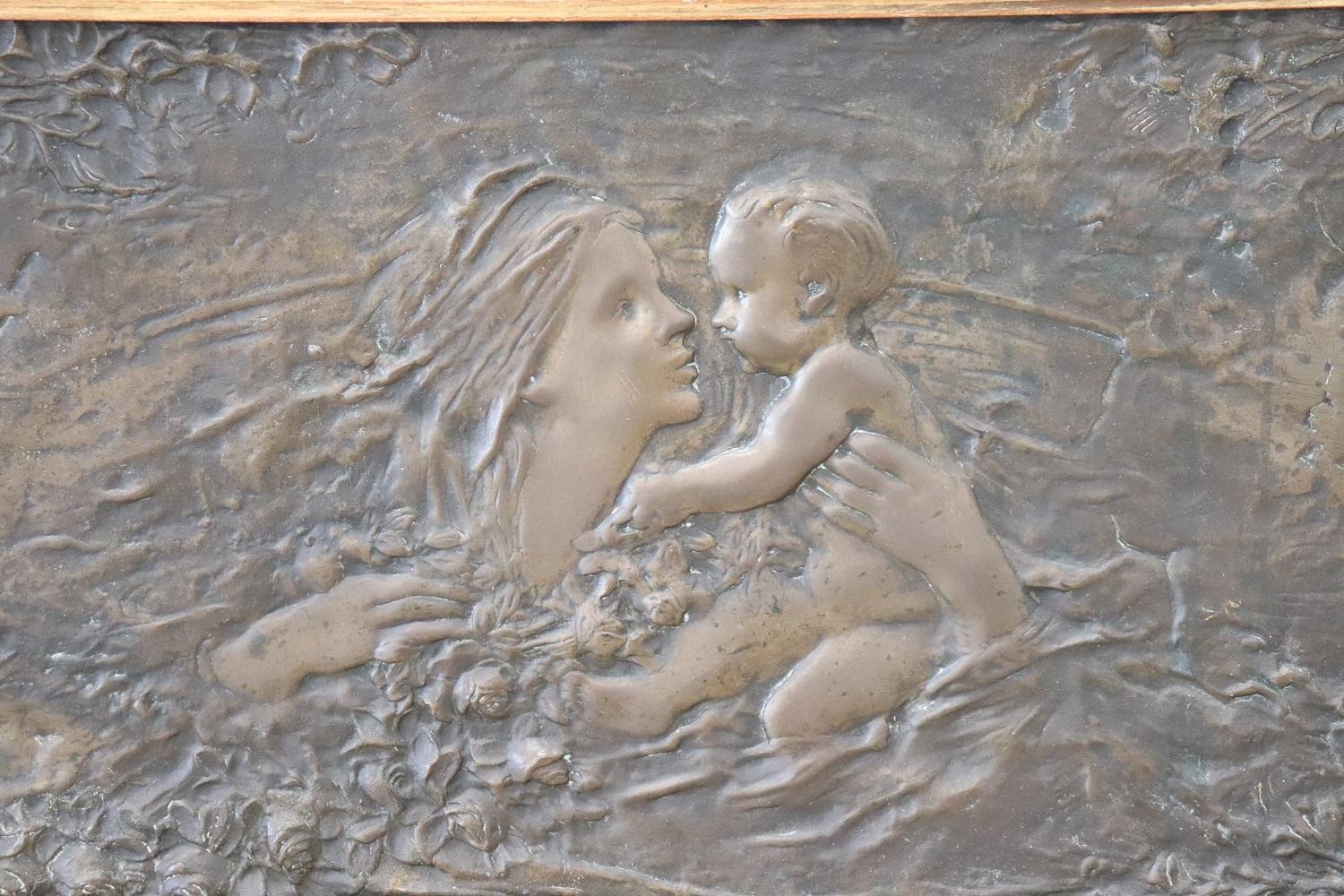 Rare Art Nouveau bas-relief sculpture in bronze. Beautiful scene with a sweet mother with her baby surrounded by flowers. Bronze of beautiful patina. Sold with a beautiful gold frame. The sculpture not signed.