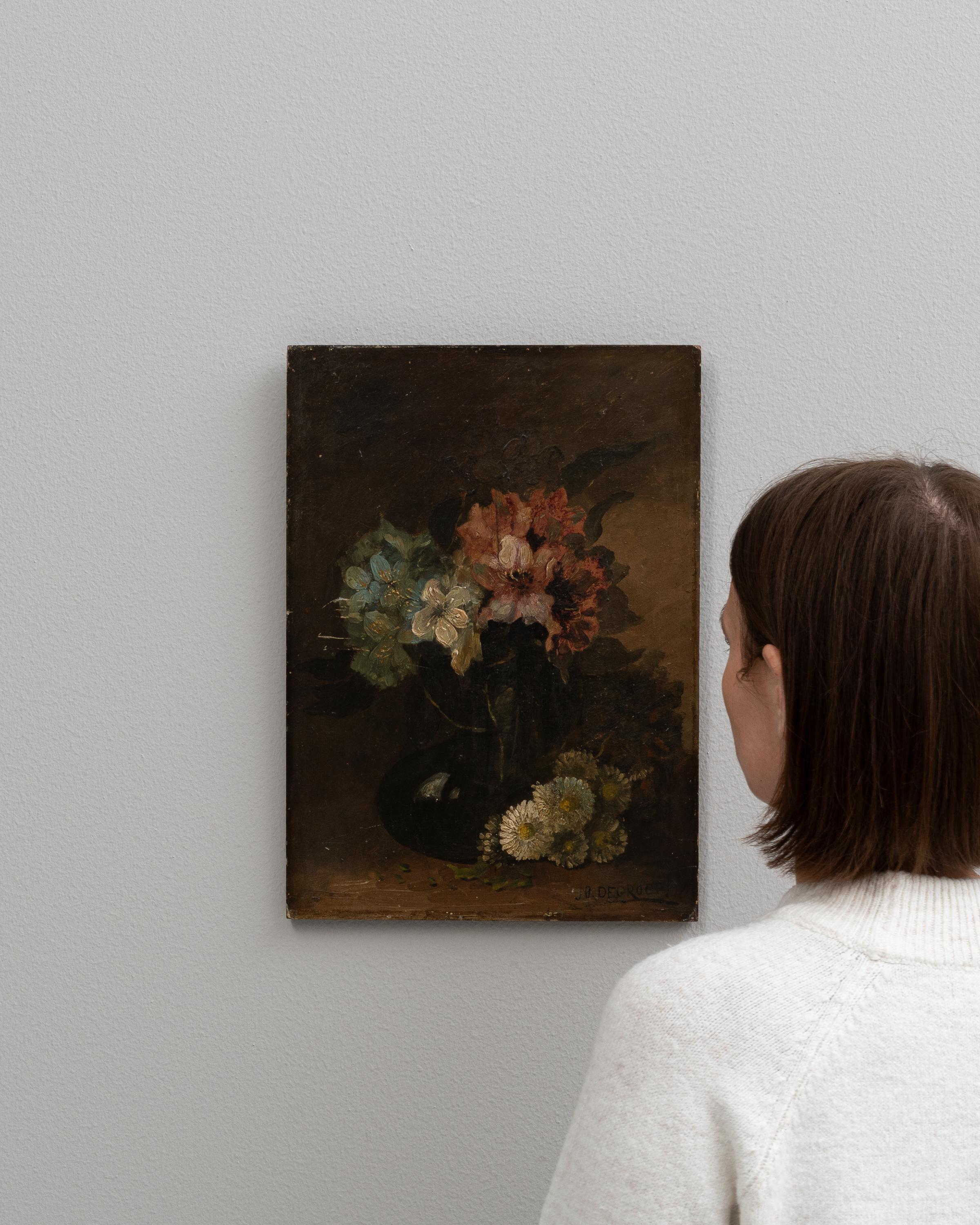 This early 20th Century Belgian painting offers a timeless still life of a floral arrangement that captures the delicate beauty and transient nature of flowers. The artist skillfully uses a muted and earthy color palette to portray an assortment of