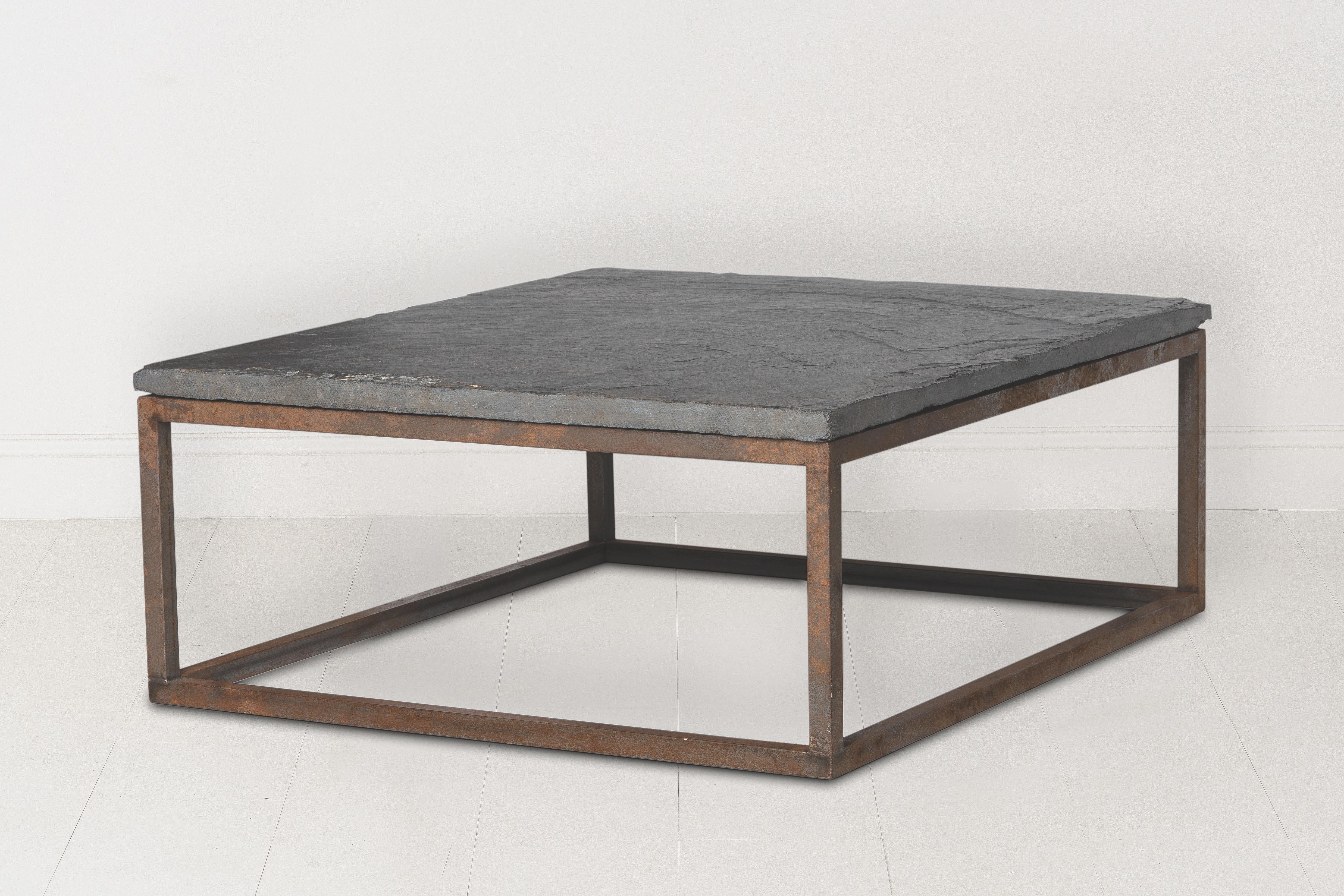An unusually thick piece of circa 1920s Belgian slate sits atop a custom iron coffee table base. Found in Belgium. The slate top is 2.44 inches thick.