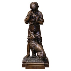 Scultura di ragazzo e cane in spelta belga dei primi del Novecento firmata V.I.I. Rousseau