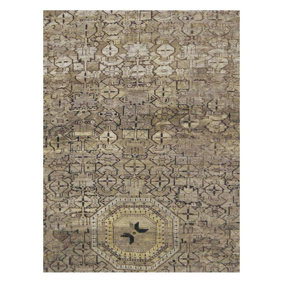 An antique Central Asian Beshir large room size tribal rug handmade during the early 20th century in neutral earth tones throughout.

Measures: 11' 1