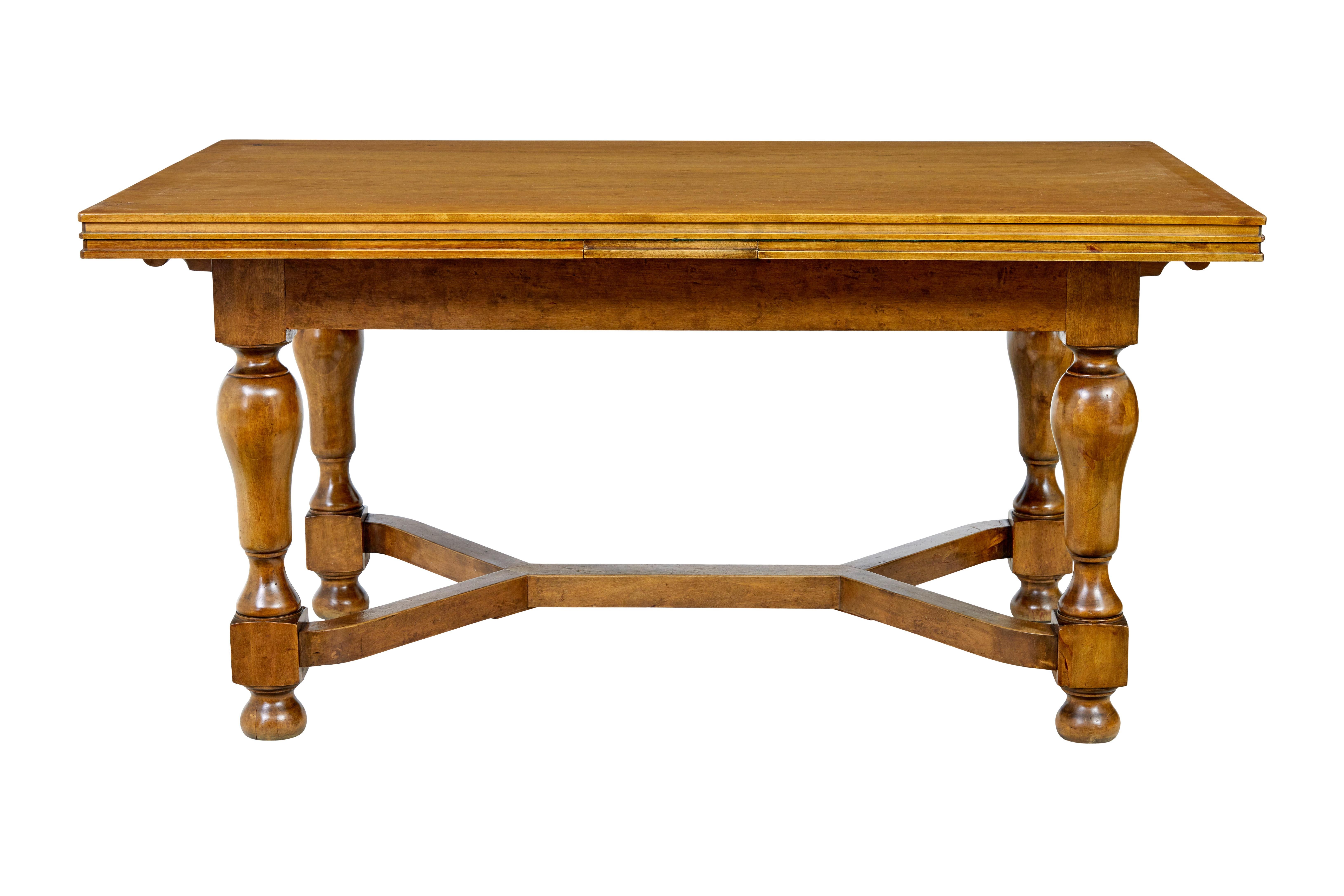 Early 20th century birch extending dining table, circa 1920.

Good quality Swedish made draw leaf dining table, styled in the classical taste with deco influences.

Rectangular birch top with good grain and rich colour, with 2 pull out pine draw
