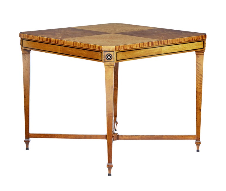 Fine quality occasional table attributed to David Blomberg, circa 1920.

Square table with canted corners, rich birch top with ebony stringing to the top and frieze. Standing on 4 tapered legs united by a X-frame stretcher.

Minor restoration to