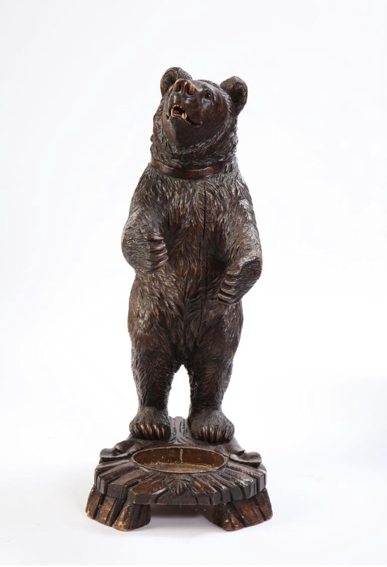 Early 20th century Swiss 'Black Forest' stick & umbrella stand in the form of a charming bear with inset glass eyes. Arms outstretched in a hug-like form the piece will fit perfectly in a front foyer or boot room. With a metal liner at the base the