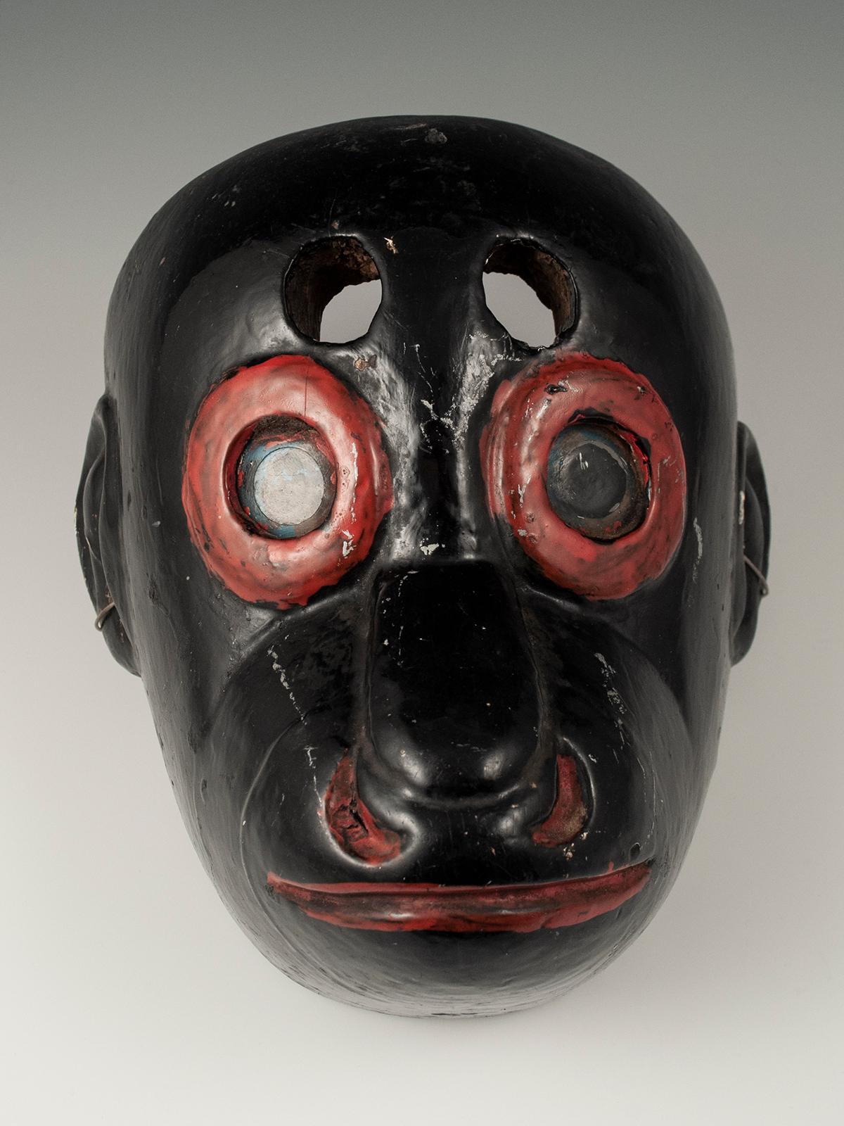 Early 20th century black monkey mask, Guatemala

A wonderful ‘monkey’ mask, which was used in the ‘Costeño’ and ‘Baile de los Animales’ Dances, and is also referred to as a ‘mico’ mask. It has glass eyes encircled by bright red rings, red painted