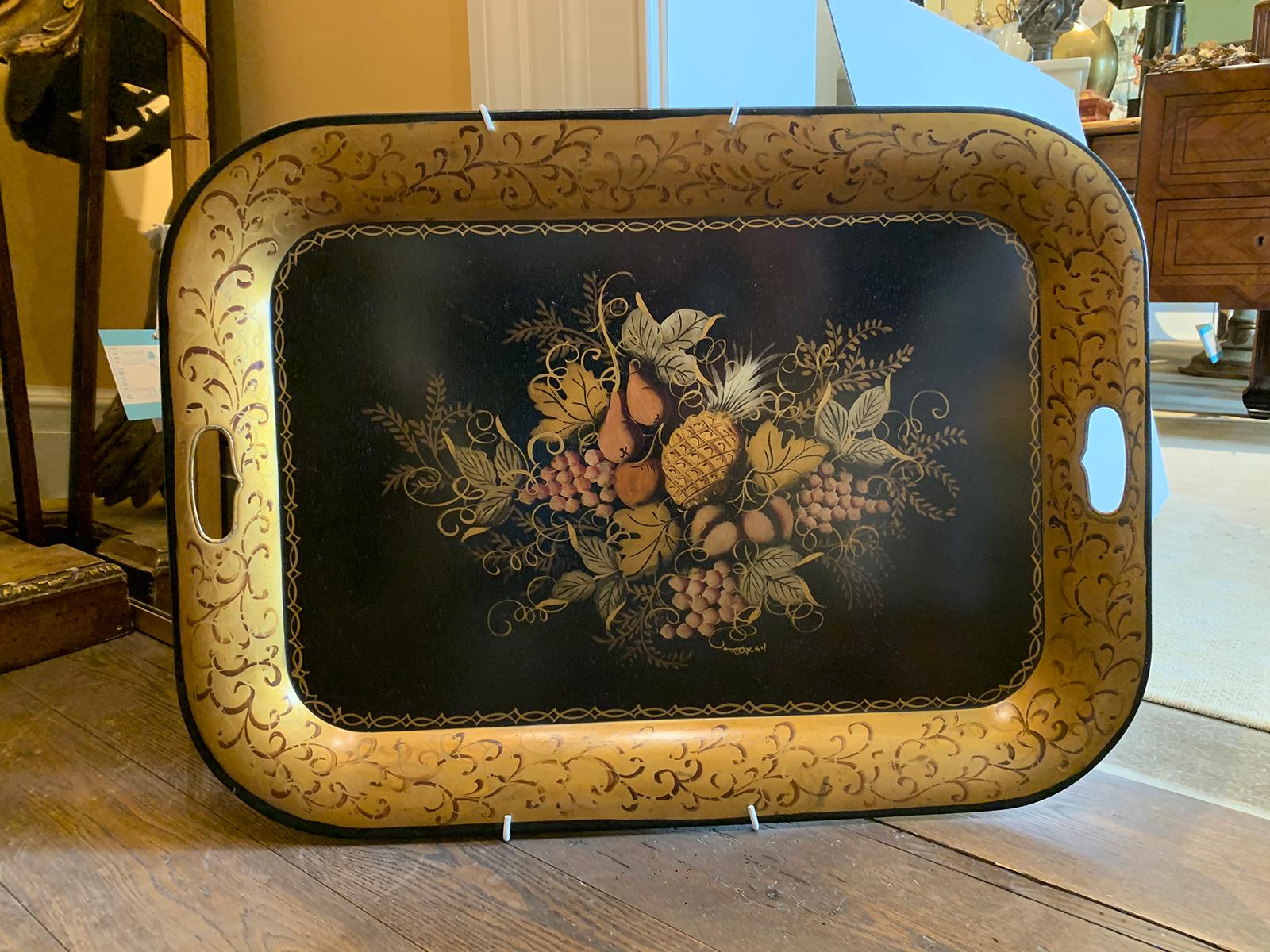 Early 20th century black tole tray with fruit detail, gilt border.