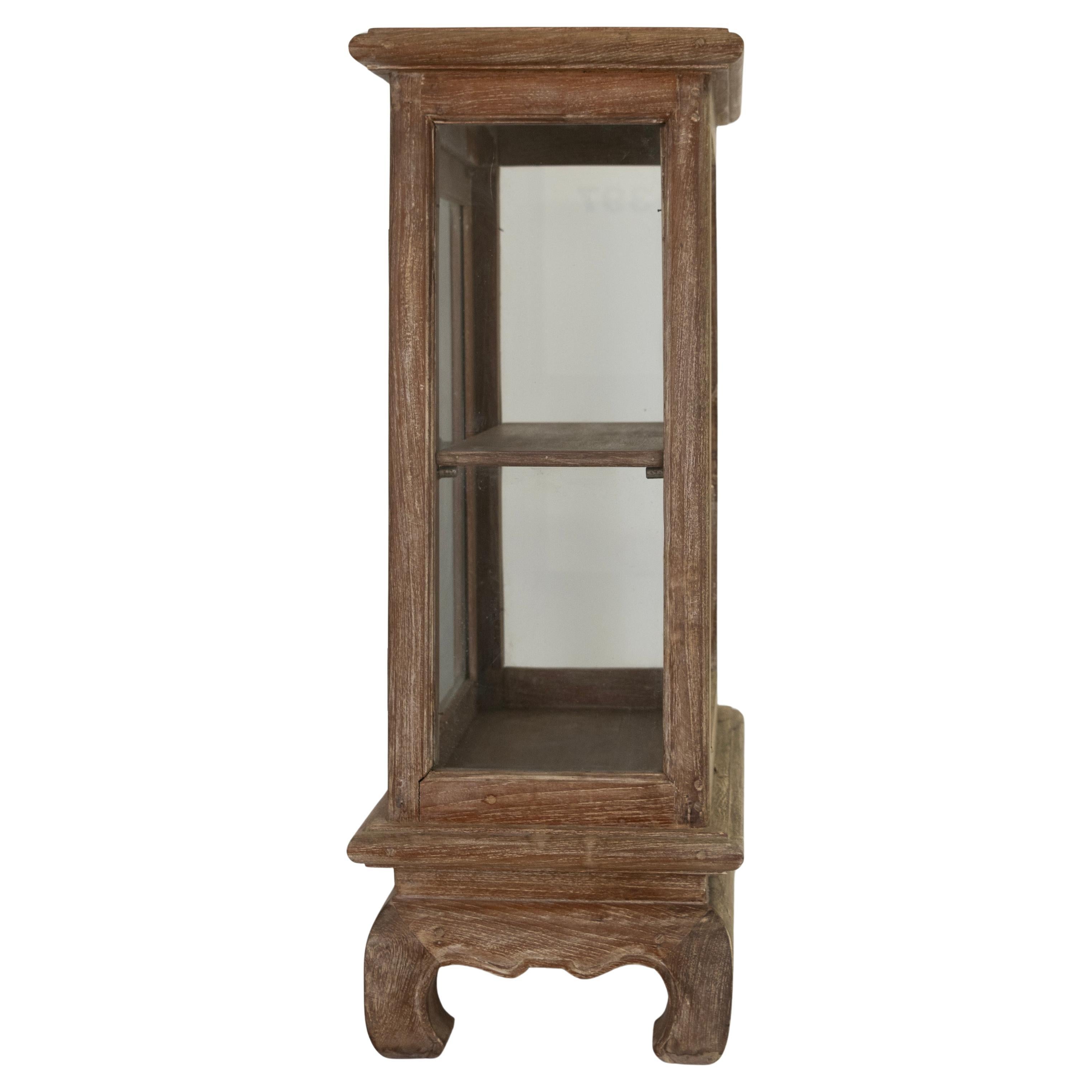 This Belgian curiosity cabinet has a beautiful, weathered patina.  The cabinet's structure is complemented by Asian-inspired ornate carvings.  This piece is ideal for displaying objects of interest.  

