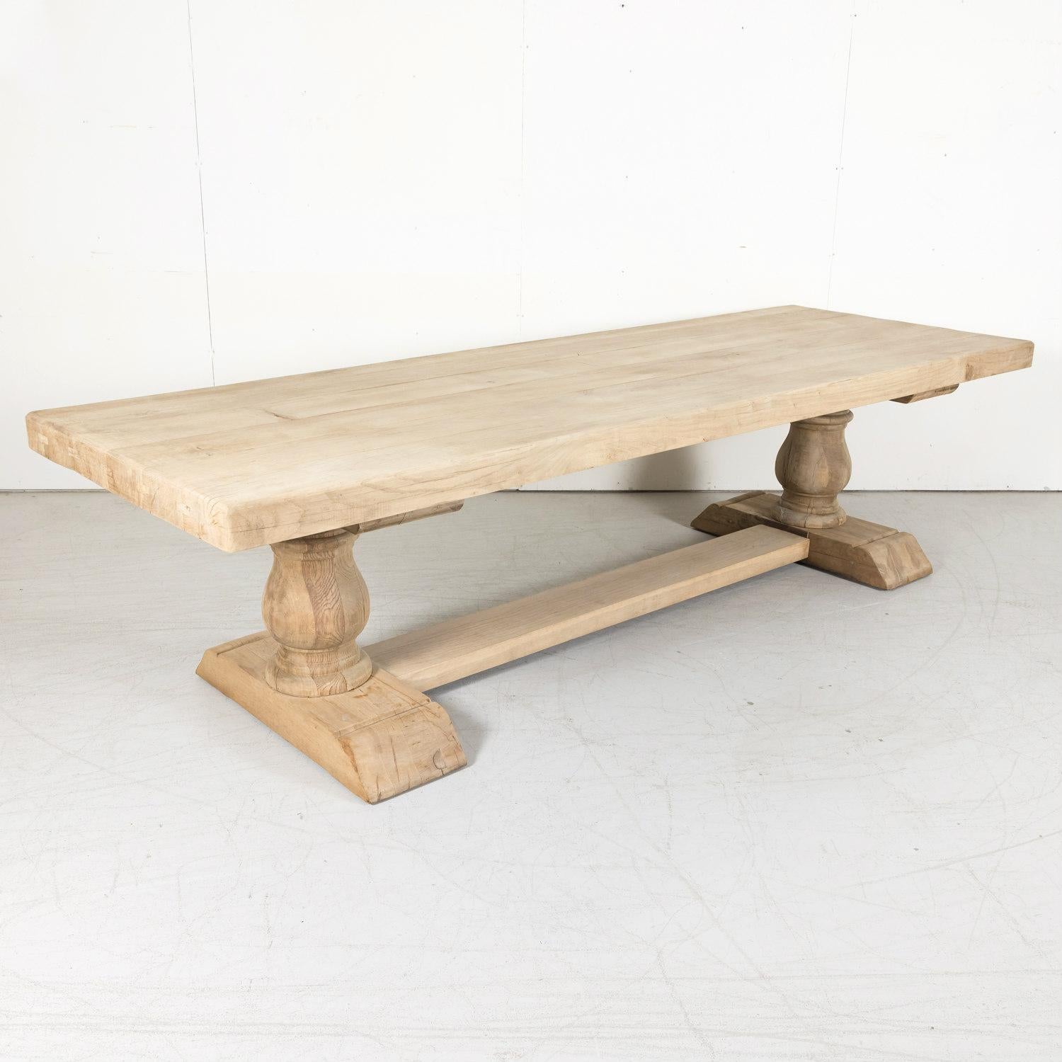 An early 20th century bleached French trestle dining table handcrafted near Avignon of solid old growth French oak, circa 1900. Having a 3.5