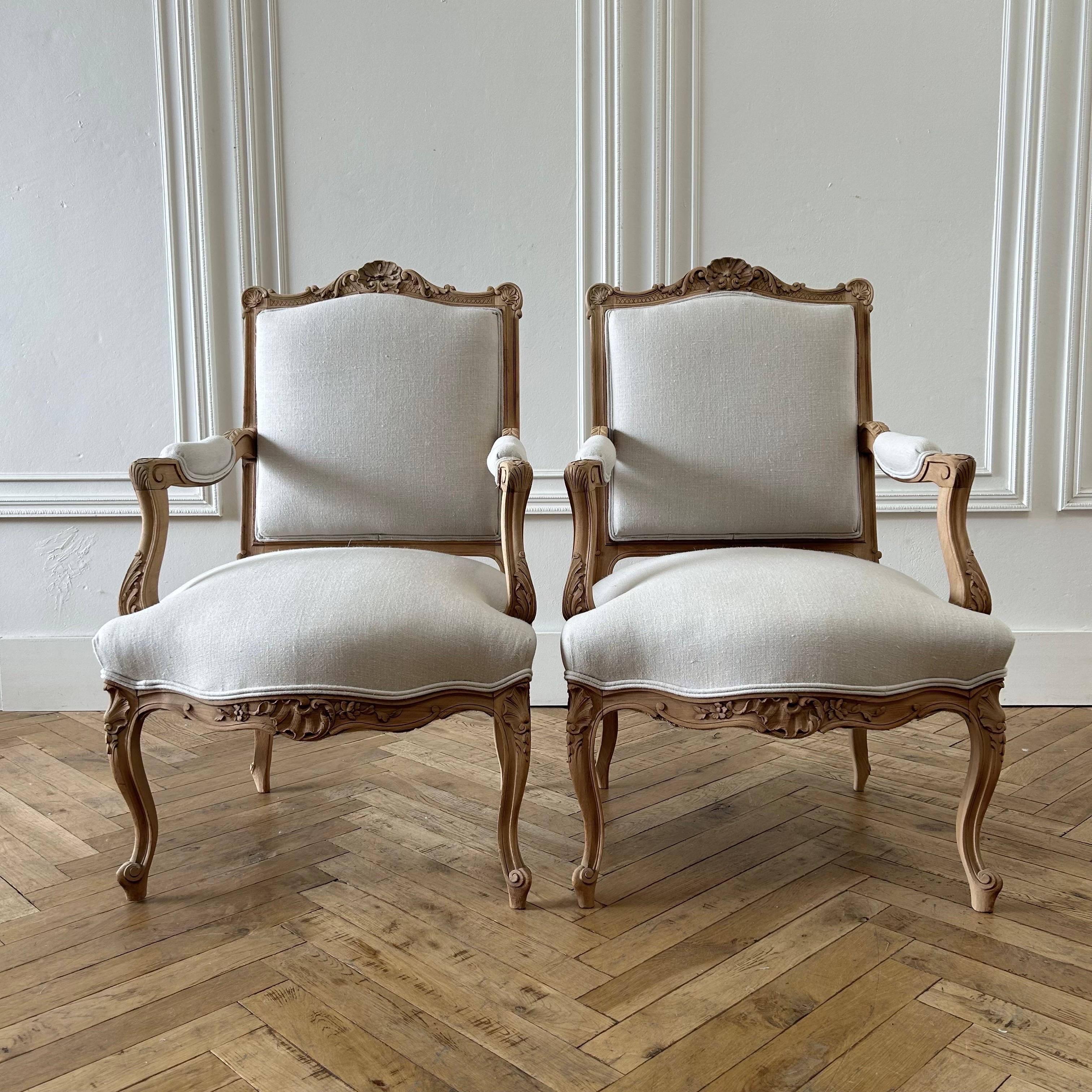Pair of vintage French Louis XV style open arm chairs
The walnut frame has a bleached raw finish, making these very organic with a vintage appeal.
The upholstery is 100% Libeco Natural Linen in Oatmeal. Finished with a double welt edge. 
Size: