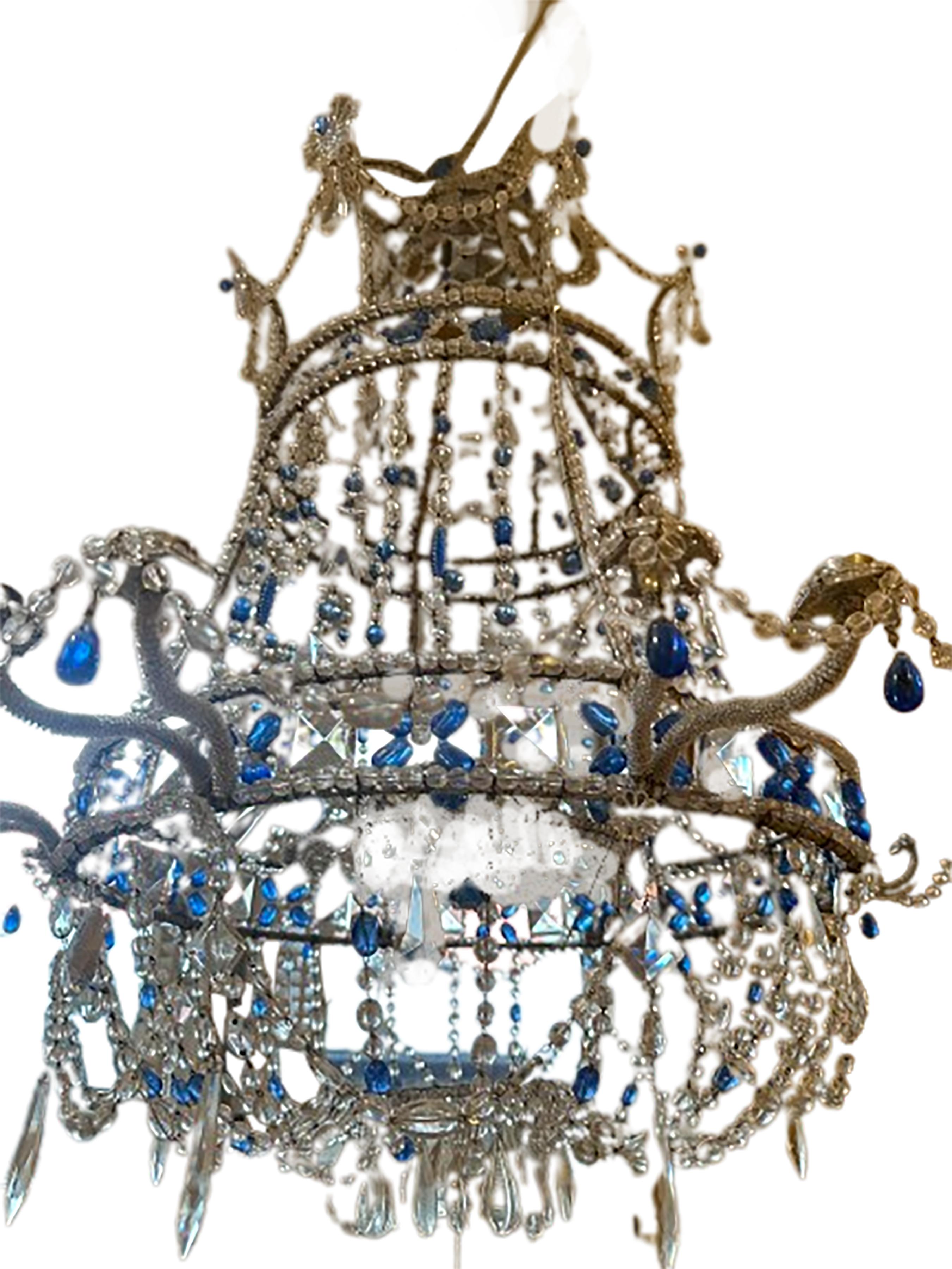 A blue and clear crystal chandelier in the Russian Imperial style. Created in the early 20th Century. Three levels of brilliantly strung crystal patterns cascade down from the top. An expertly structured frame canopy encircles the top, mid, and