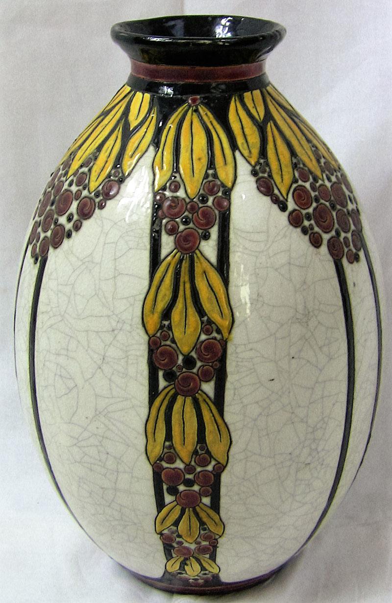 This is a beautiful Art Nouveau example, pre-WWI, circa 1910. Fully marked B.F.K. vase. Pattern D746.
The white earthenware baluster form vase with cream crackle glaze ground and multi-color floral design.
Minor repair to rim, professionally