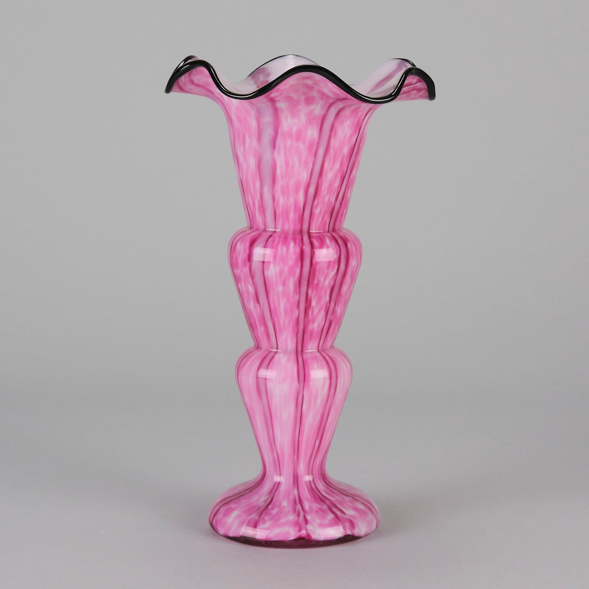 An eye catching pink and white 'vertical stripes' blown glass vase with inner white casing, and applied black glass undulating terfoil rim.

ADDITIONAL INFORMATION
Height: 24 cm 

Diameter: 13 cm 

Condition: Excellent Original