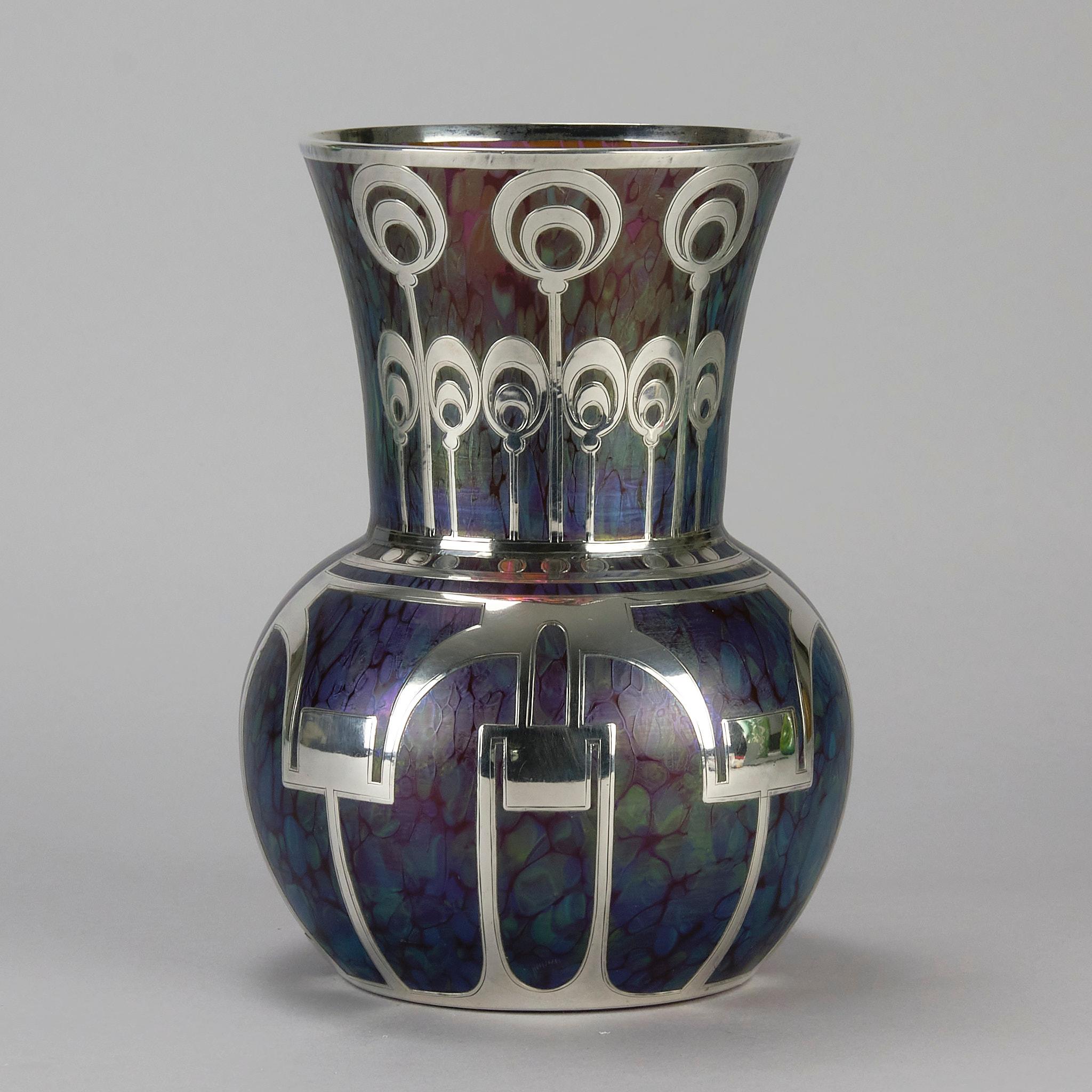 A highly attarctive early 20th Century Medici Secessionist vase by Loetz Witwe, the iridescent purple and golden glass vase with a beautiful geometric applied silver decoration

ADDITIONAL INFORMATION

Height:                                      19