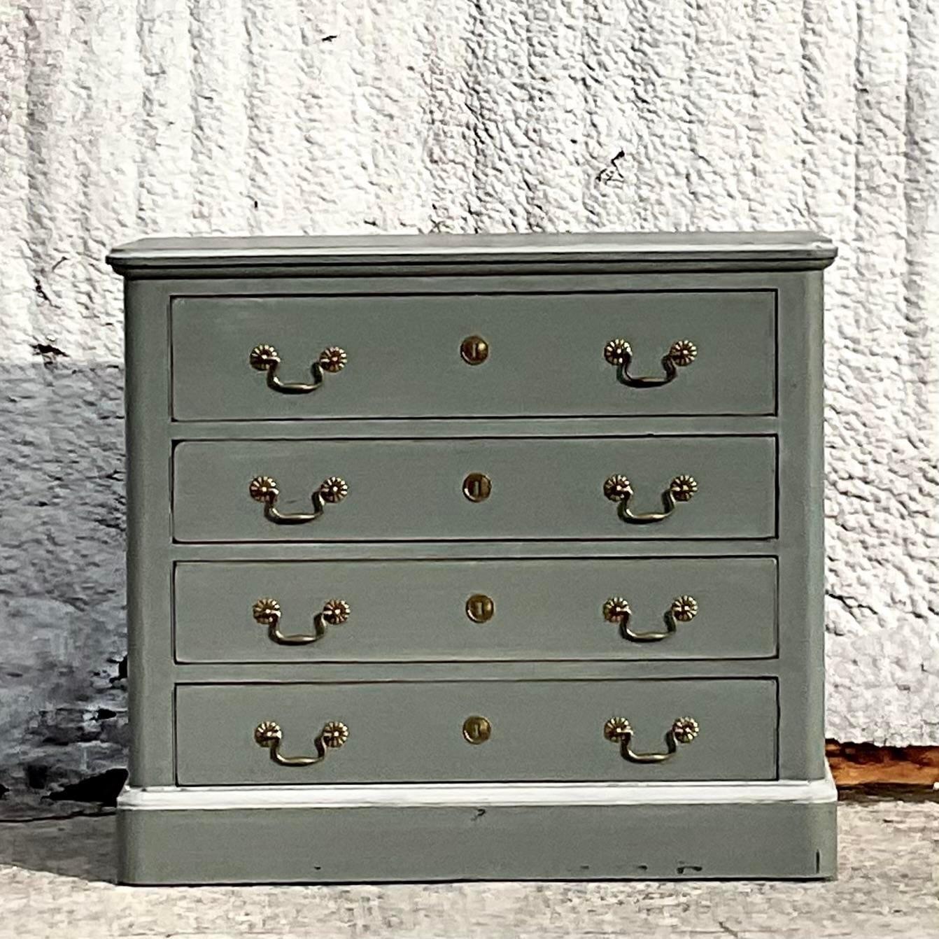 A fabulous vintage Boho chest of drawers. A chic little cabinet painted a dove grey with white tipping. Burnished brass hardware. Acquired from a Westport estate.