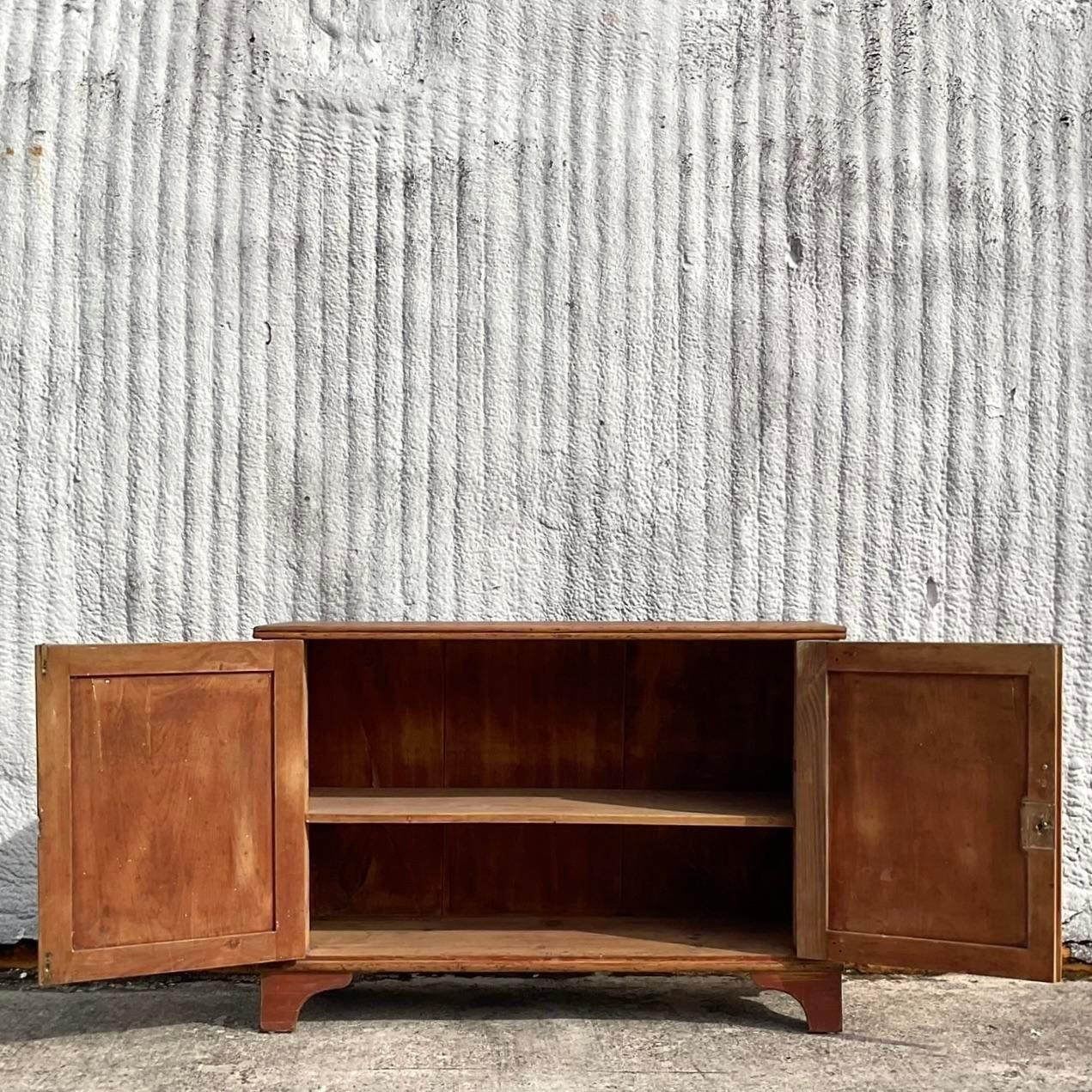 A fantastic vintage rustic sideboard. Chic turned wood detail and a great all over patina from time. Lots of great storage below. Acquired from a Palm Beach estate.