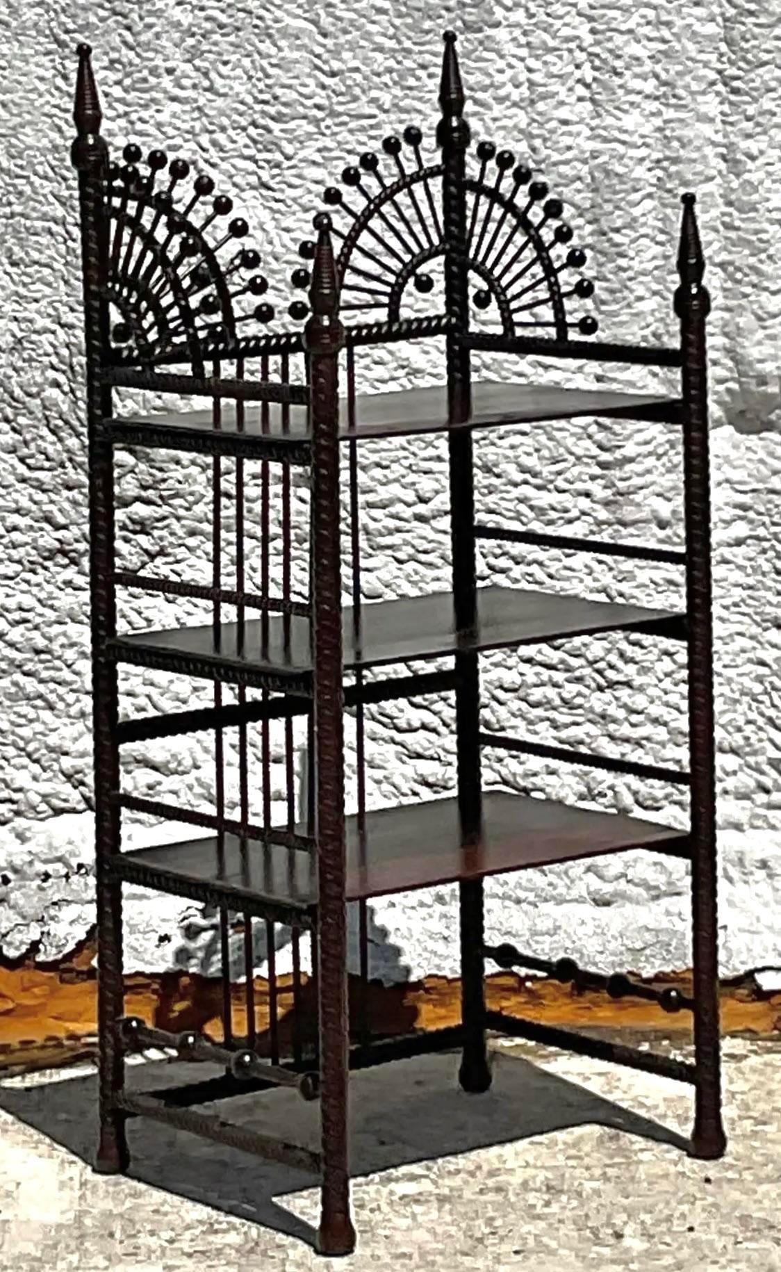 Embrace Bohemian elegance with a touch of Americana using this Vintage Boho Stick and Ball Petite Etagere. Crafted with intricate stick and ball detailing, it exudes a whimsical charm reminiscent of 19th-century American craftsmanship. Perfect for