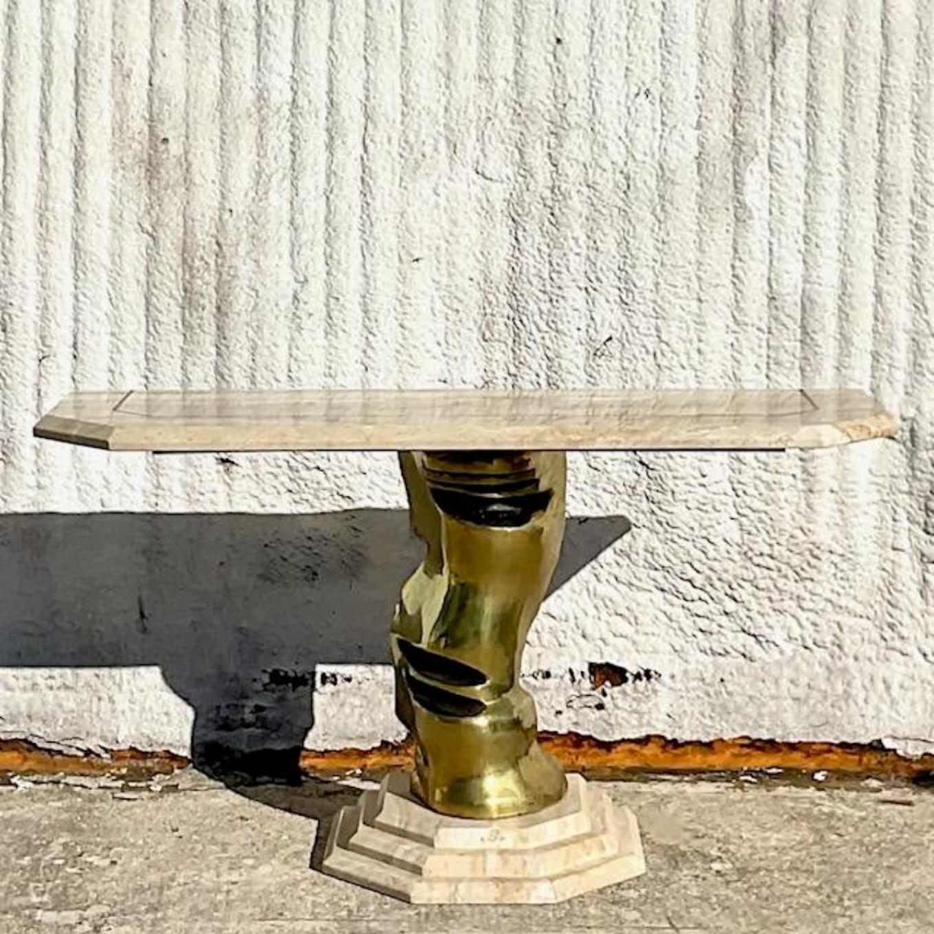 A fabulous vintage Boho console table. A chic sculpted brass pedestal with a tessellated stone top and stacked plinth. Signed in the back. Acquired from a Palm Beach estate.