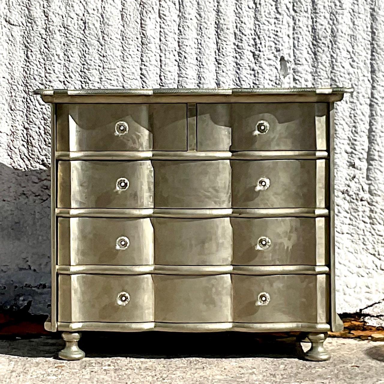 A fabulous vintage Boho chest of drawers. A chic silver leaf cabinet with a striking wave front design. Hand carved detail along the edge. Acquired from a Palm Beach estate.