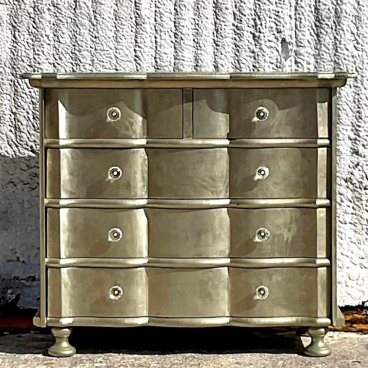 A fabulous vintage Boho chest of drawers. A chic silver leaf cabinet with a striking wave front design. Hand carved detail along the edge. Acquired from a Palm Beach estate. 