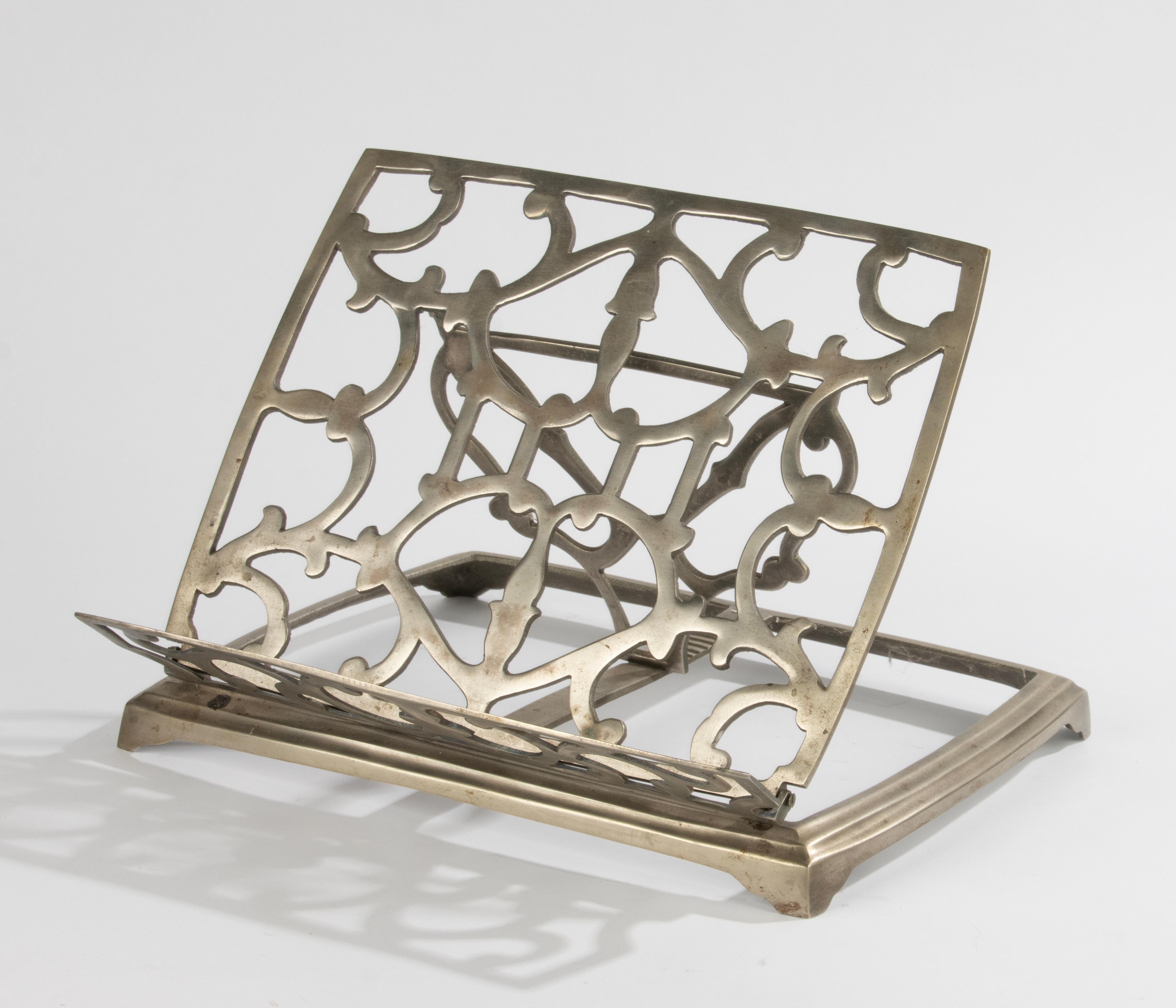 A nice antique lecture stand, beautifully decorated with geometric motifs. Made of nickel plated brass.
The rack is in good condition. Stands firm and stable. Can be adjusted in different positions. Also foldable.

Dimensions: 29 x 29 cm and 21 cm