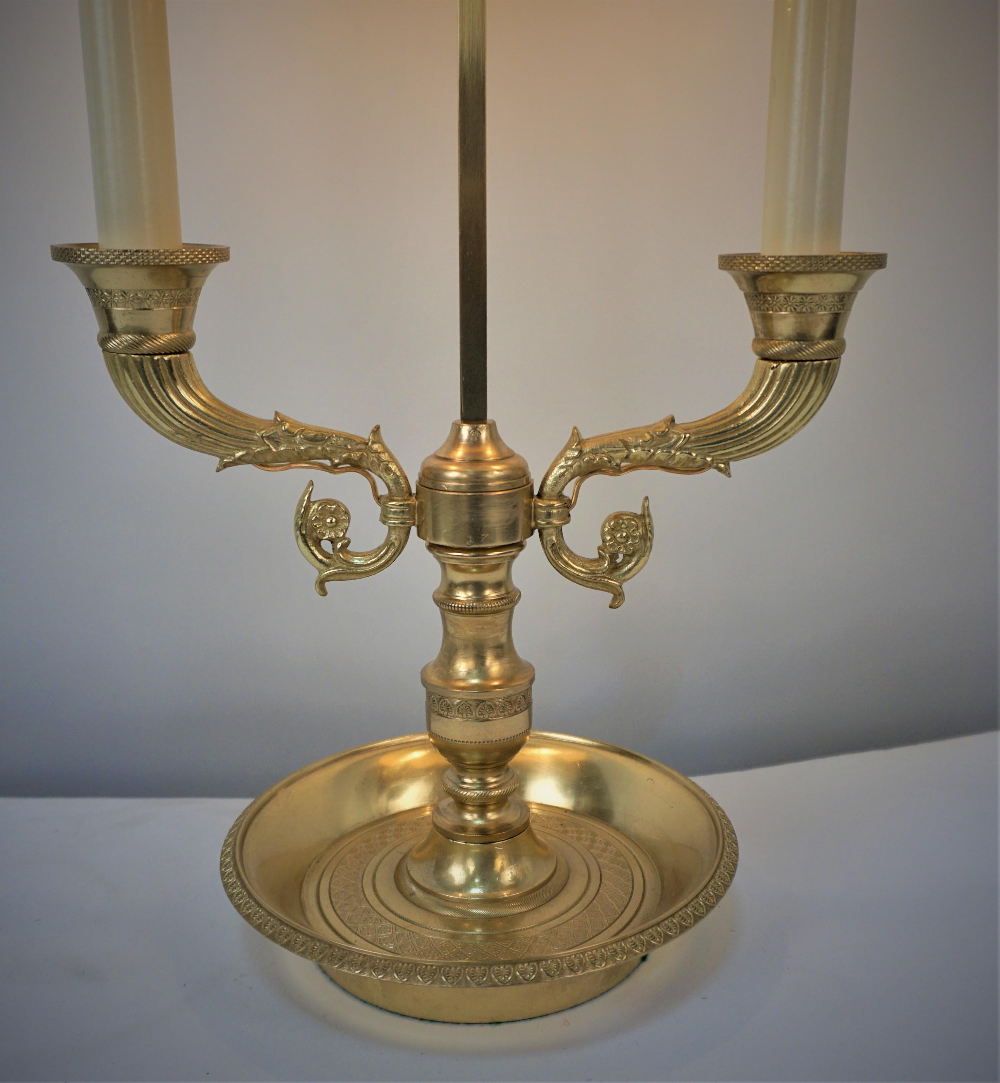 Crafted in early 20th century France, this table lamp features a beautiful bronze candelabra base. The lamp has been professionally electrified and restored and has two lights.