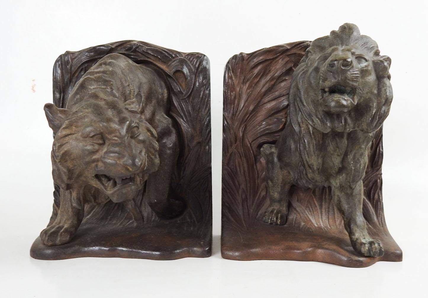 Antique circa 1915 cast iron Bradley and Hubbard lion and tiger bookends.  Very striking and quite heavy, over 7 pounds each, marked BH on backs.  Dimensions are for one bookend, overall dark patina.