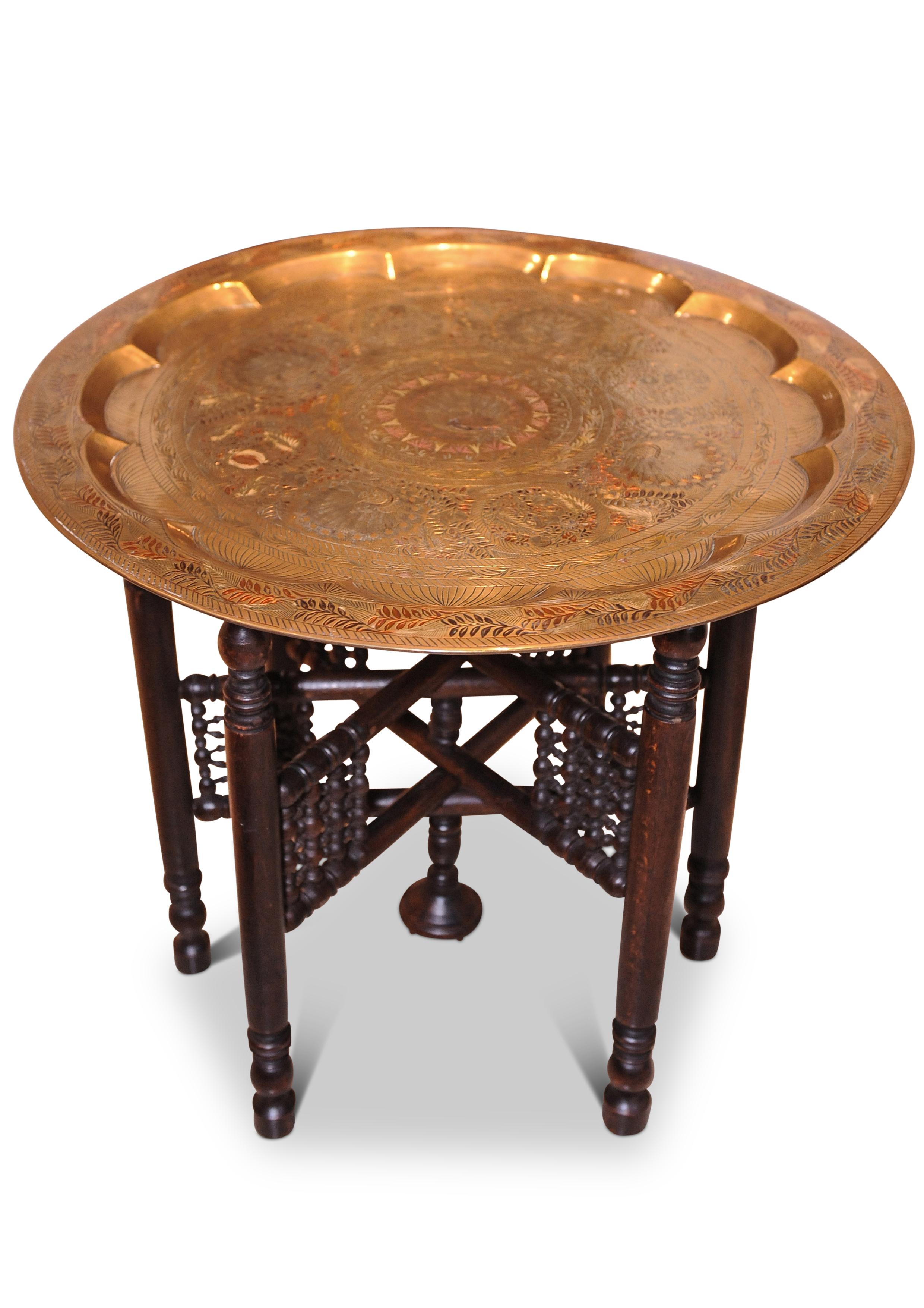 Early 20th century brass and hardwood tea table decorated with peacocks from the middle east
Table folds.

.