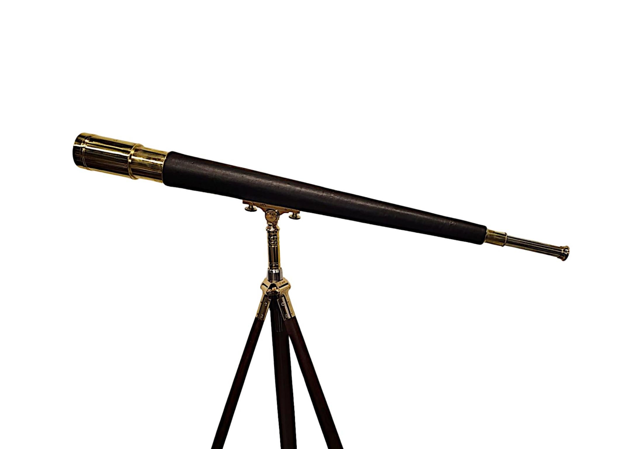 A stunning early 20th Century telescope brass and leather coast guard telescope of exceptional quality and with excellent optics.  The finely cast polished brass and leather telescope.  Supported on a gorgeous finely carved, well figured and richly