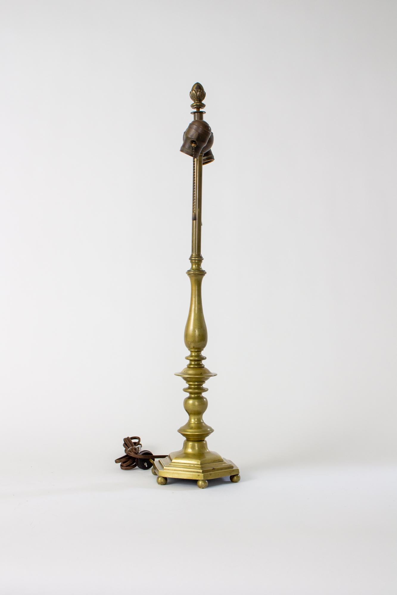 Early 20th century brass candlestick table lamp. Hexagonal base with turned stem pieces. Original two light cluster. Classic style and fine quality. Light patina on brass. Of the same quality of E.F. Caldwell lamps of the same era, but without