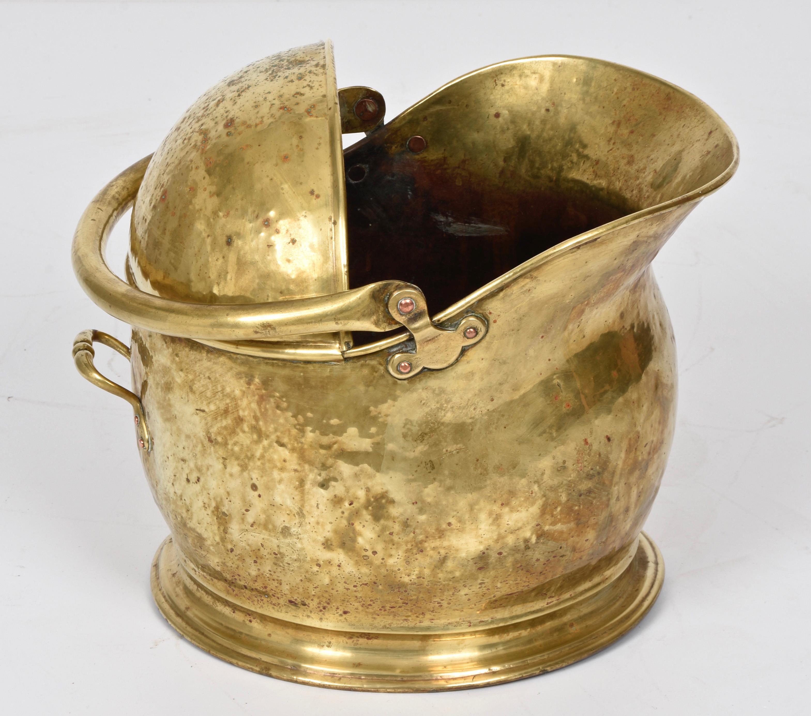 Stunning brass charcoal scuttle in the shape of a wonderful helmet. This amazing piece was designed in Italy in the 1930s.

This piece is unique in that it is shaped like a wonderful helmet with an incredible handle. Solid brass is gorgeous, hand