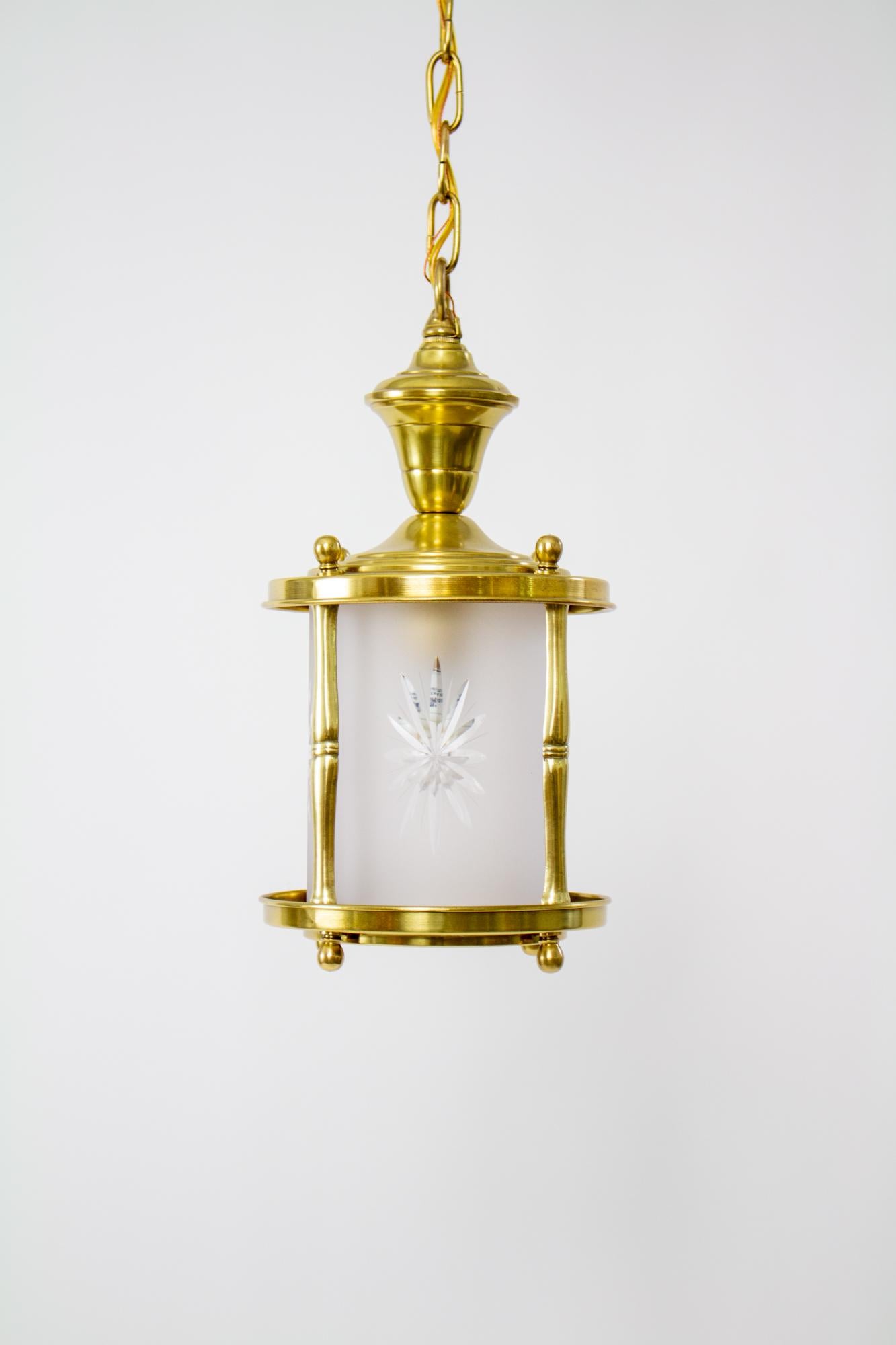 Early 20th Century small lantern with frosted star cut glass. Colonial revival style lantern, all brass with a top and bottom brass ring, four columns and knobs at top and bottom. The central glass cylinder is original and in excellent condition. It