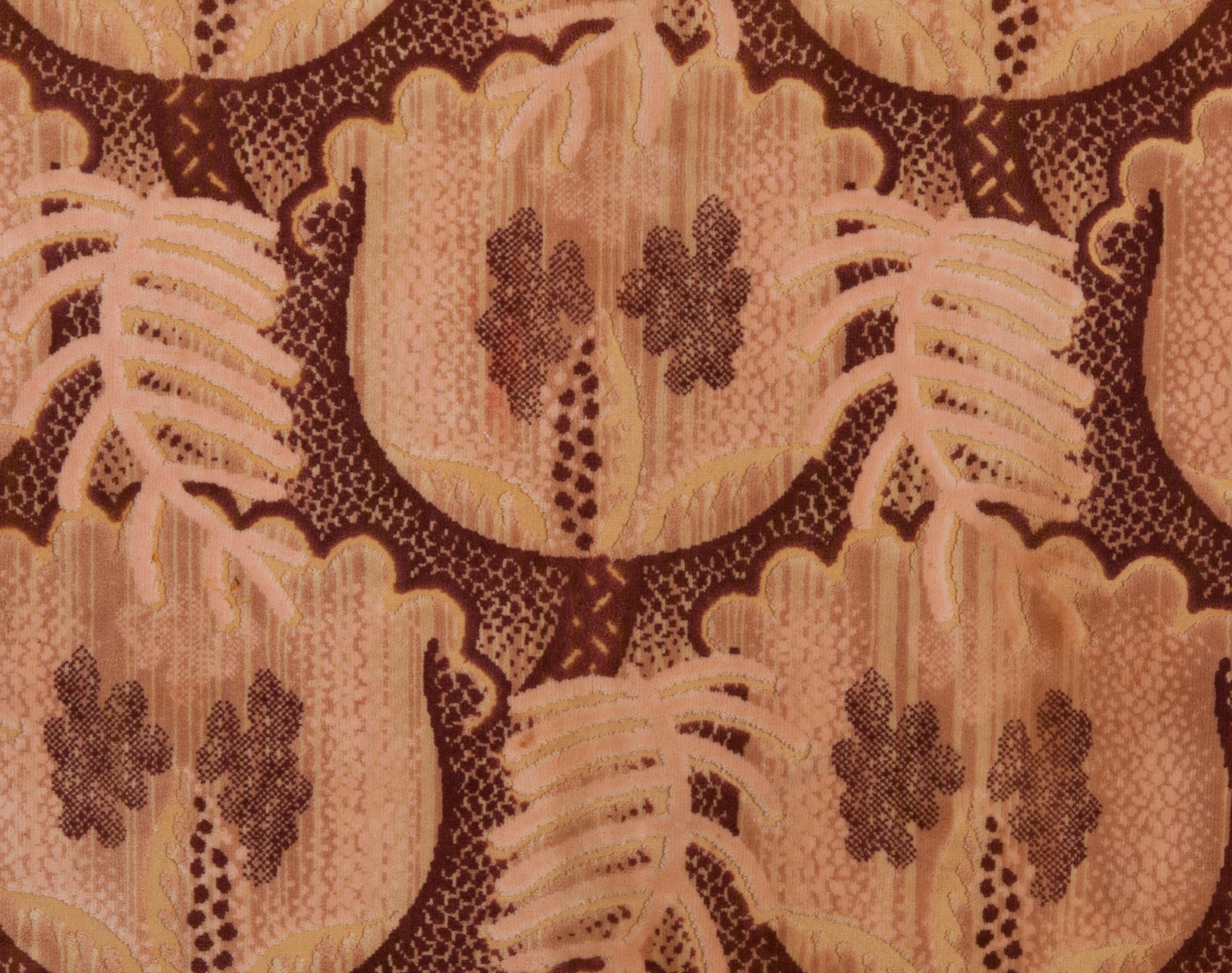 An industrially manufactured Art Nouveau voided velvet furnishing fabric in a bold stylized leaf/flower design. Made in the UK, early 20th century.