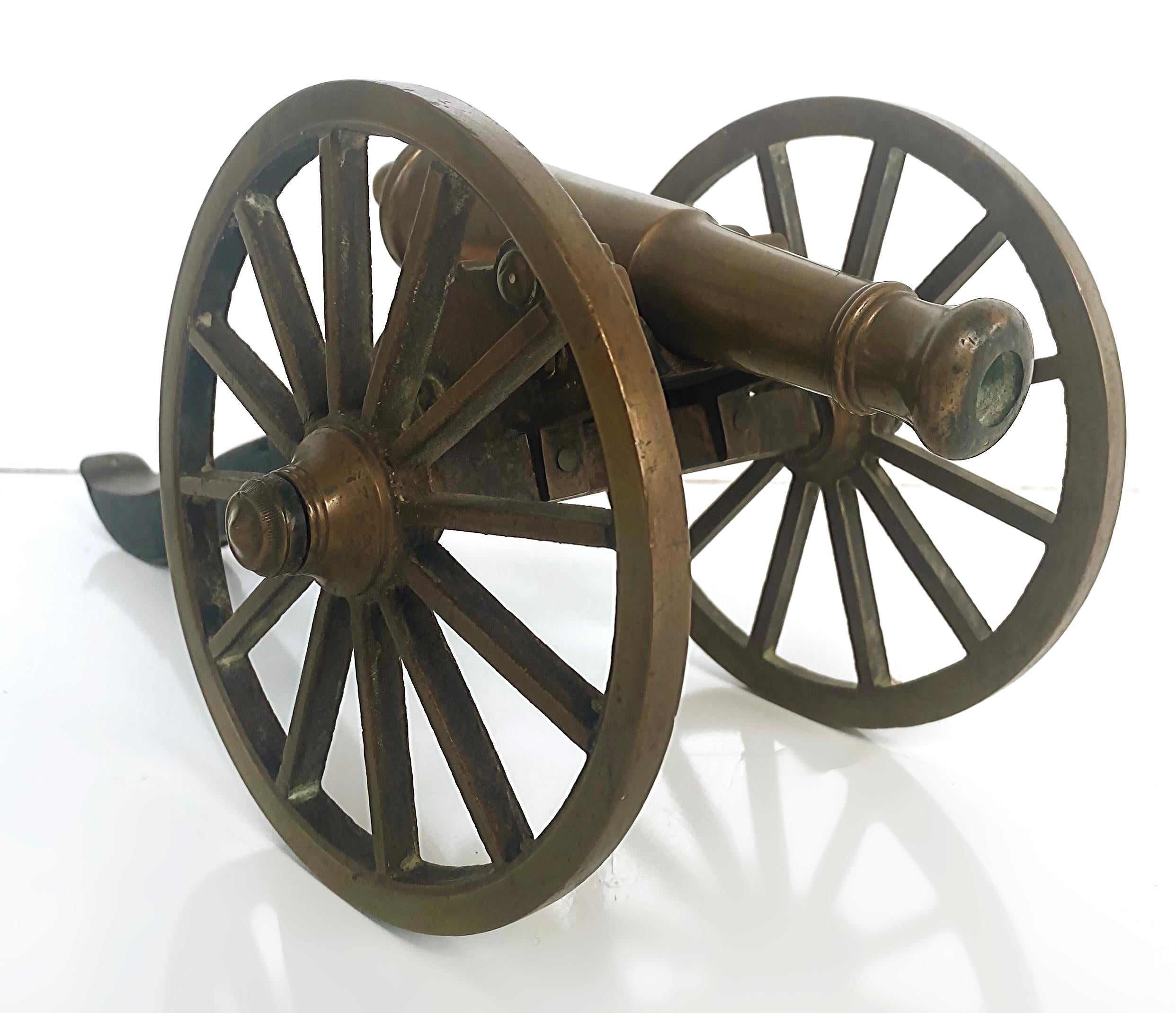 Early 20th Century Bronze and Wood Mounted Cannon Model 

Offered is an early miniature bronze cannon on a wood carriage with large bronze wheel. This will be displayed nicely on a desk or on shelves. 
