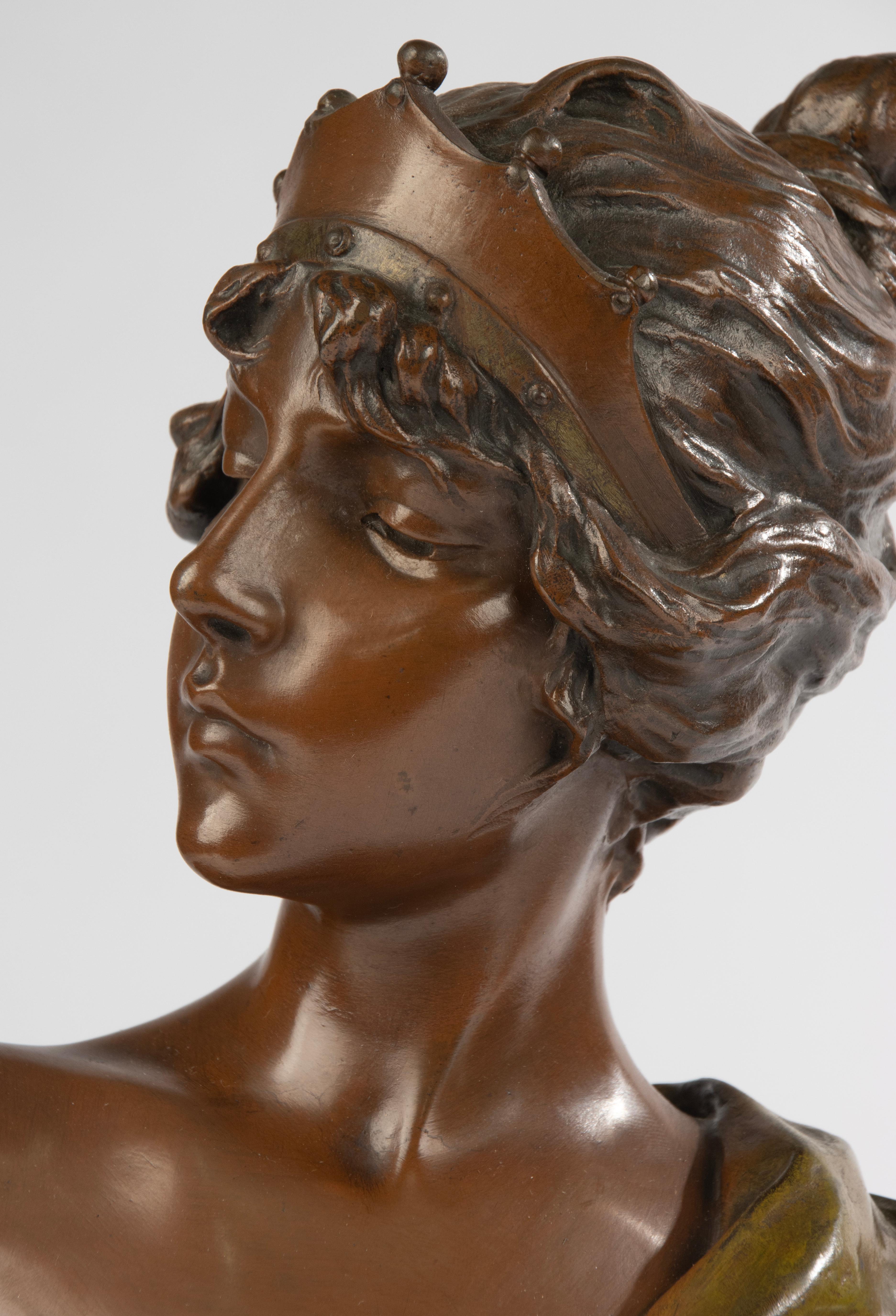 A beautiful bronze bust of the Roman woman Lucretia. The statue is by Emmanuel Villanis, a French sculptor who was active at the turn of the century. 
The statue has a beautiful color, multi-colored patina. The sculpture has a beautiful shine and