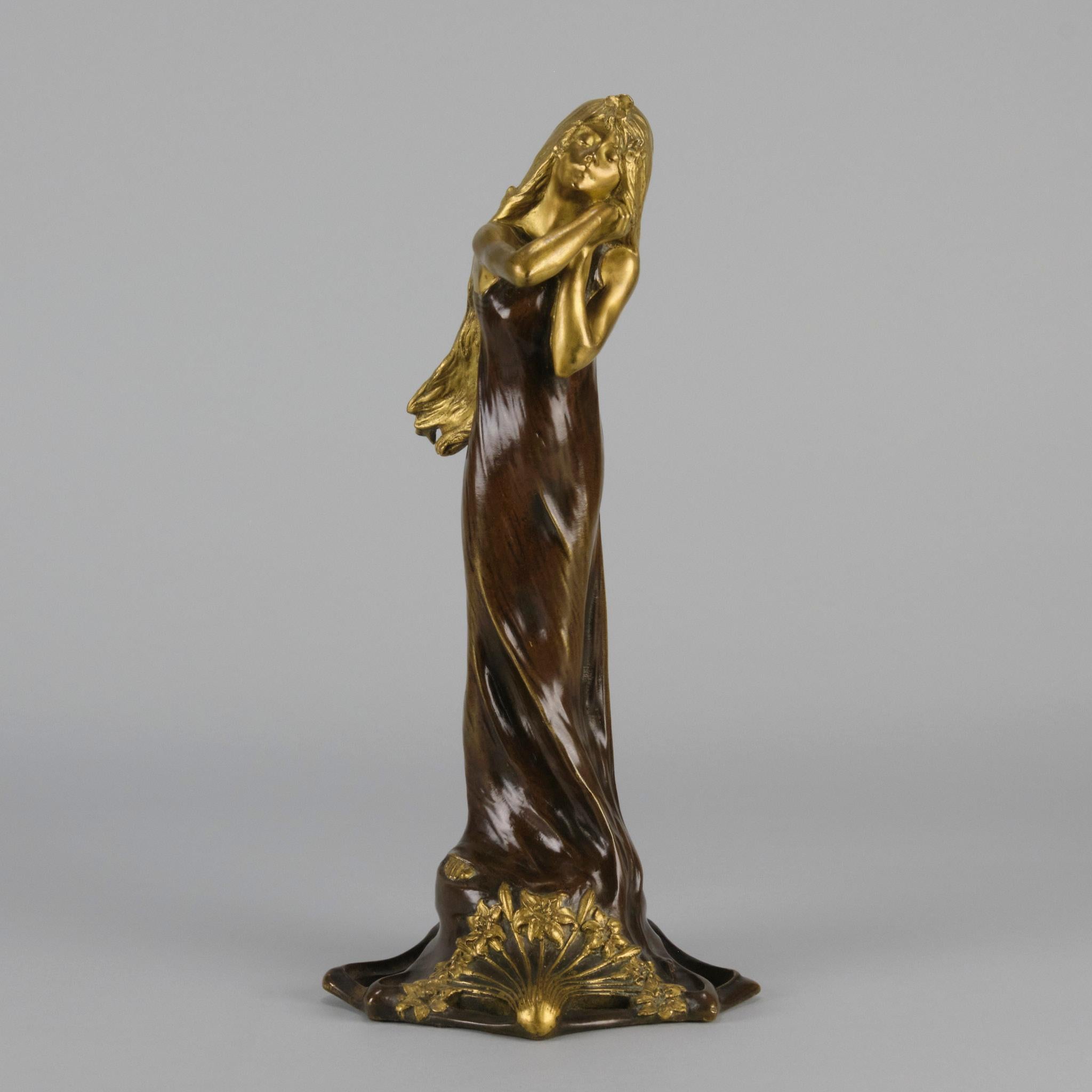 A very fine Art Nouveau bronze study of a young beauty in coy pose, clothed in a long flowing skirt, her head and arms in gilt bronze to contrast with the rich brown colour of her clothes. The surface of the bronze with excellent hand chased surface