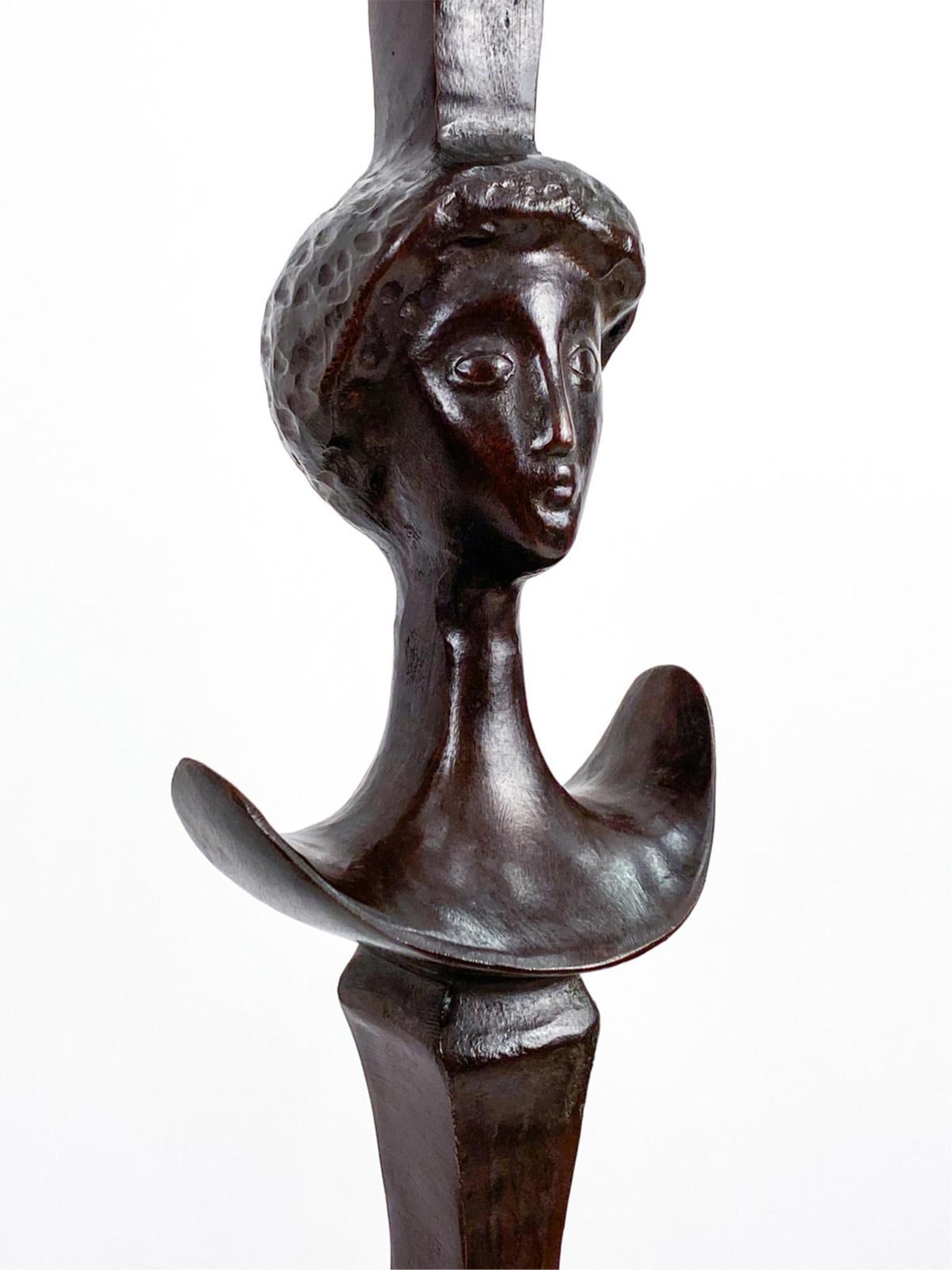 This absolutely stunning Bronze floor lamp was designed in the style of preeminent Modernist sculptor Alfred Giacometti. It is constructed in a dark brown patinated bronze, showcasing a sculptural form of woman's head that is full of expression, and