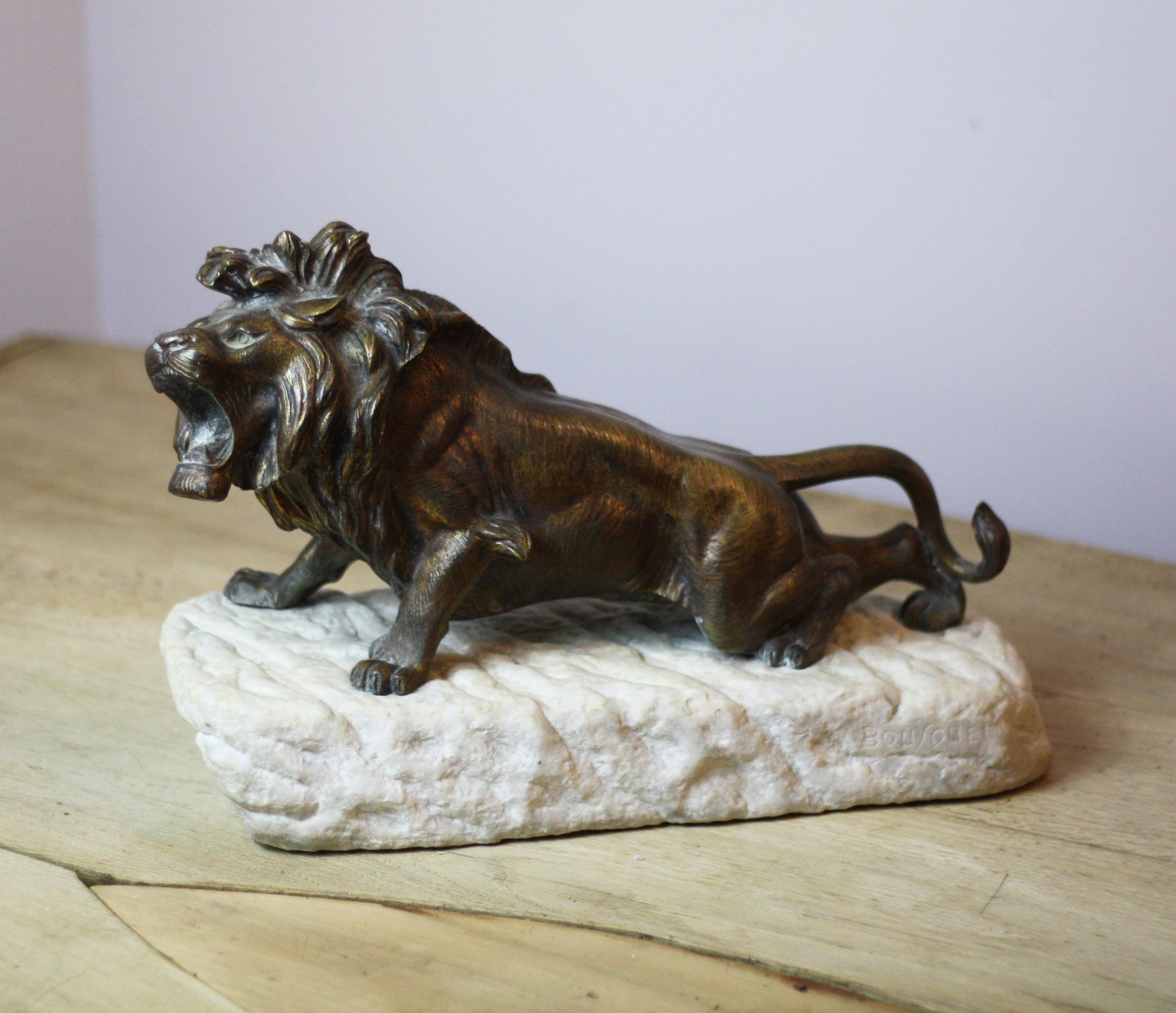 Handsome bronze lion on carved stone base by acclaimed French sculptor Robert Bousquet, 1894-1917.