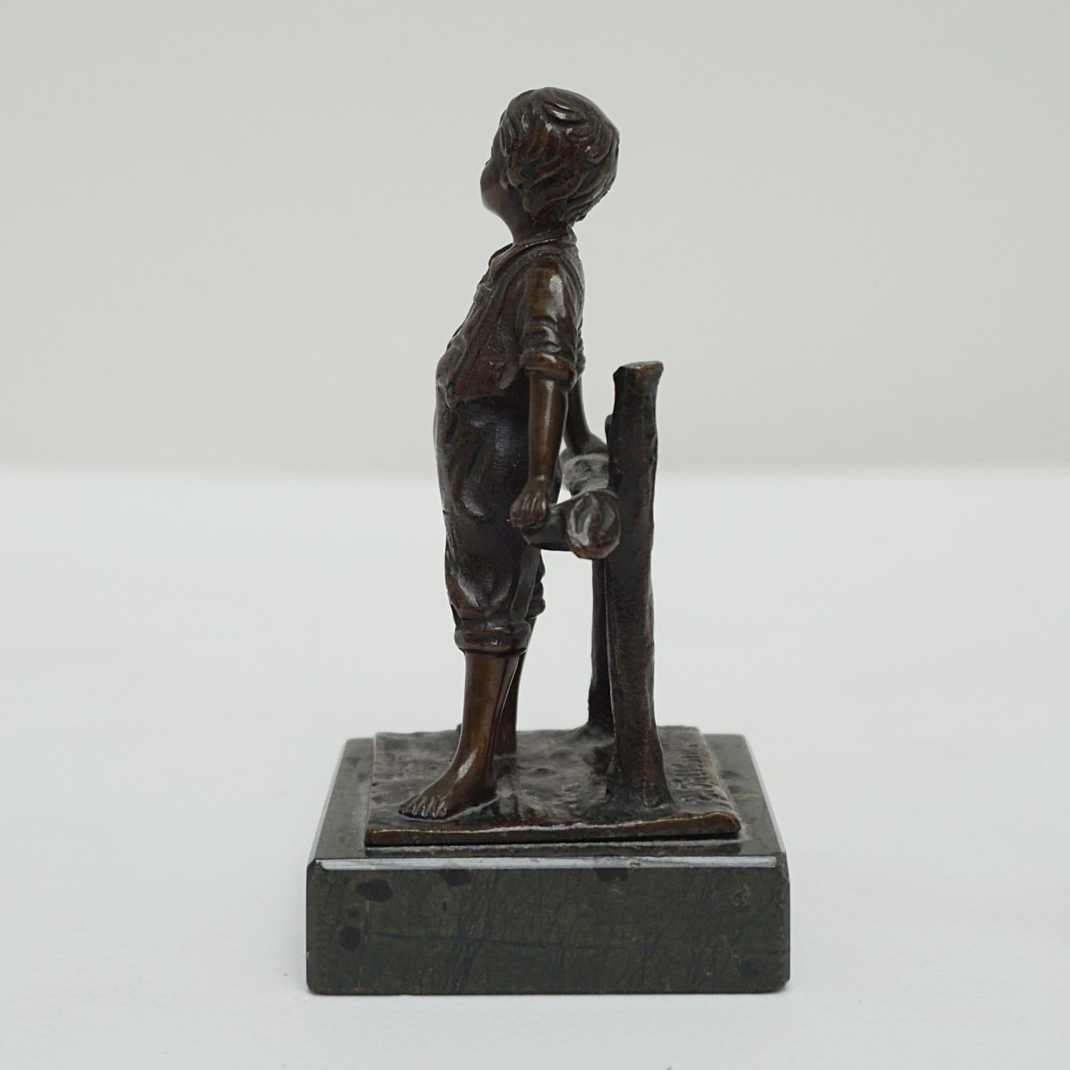 An early 20th century bronze sculpture of a playful young boy leaning against a fence. Set over original black marble base and signed E.Fillbon to bronze. 

Dimensions: H 10cm W 5.5cm D 5.5cm 

Origin: French

Date: circa 1910

Item Number: