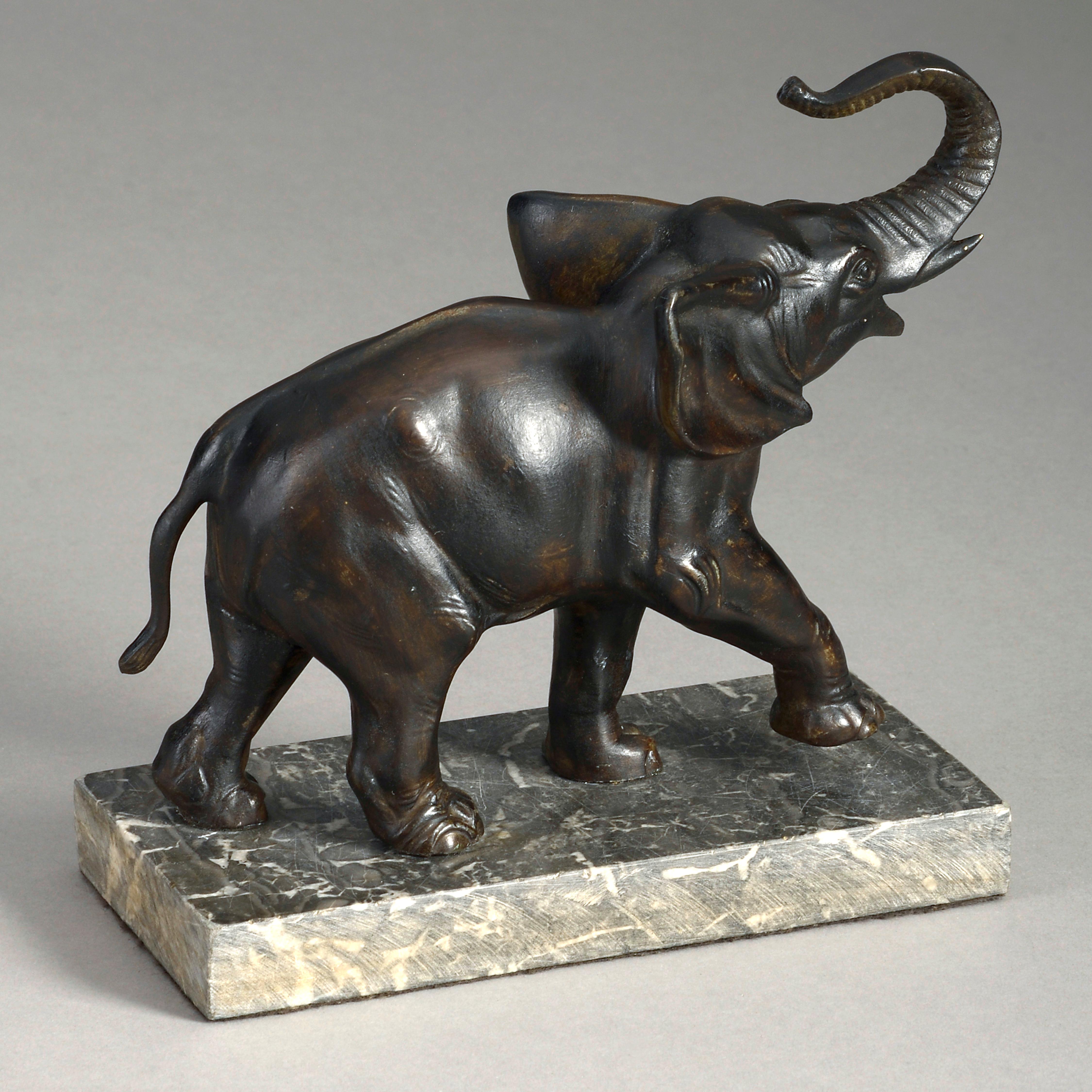 An early twentieth century bronzed sculpture depicting an elephant, naturalistically cast and set upon a marble base.