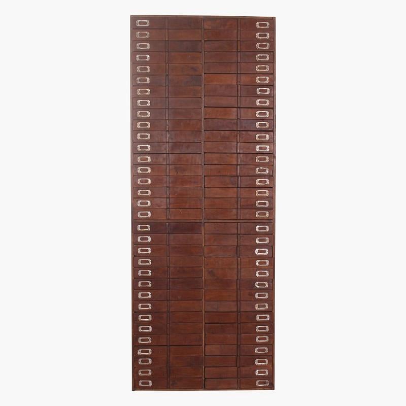 An extraordinary early 20th century Brutalist chest of drawers from India, discovered in an abandoned factory. Crafted from solid teak, this monumental piece embodies both raw functionality and striking sculptural form.

Featuring a total of 66