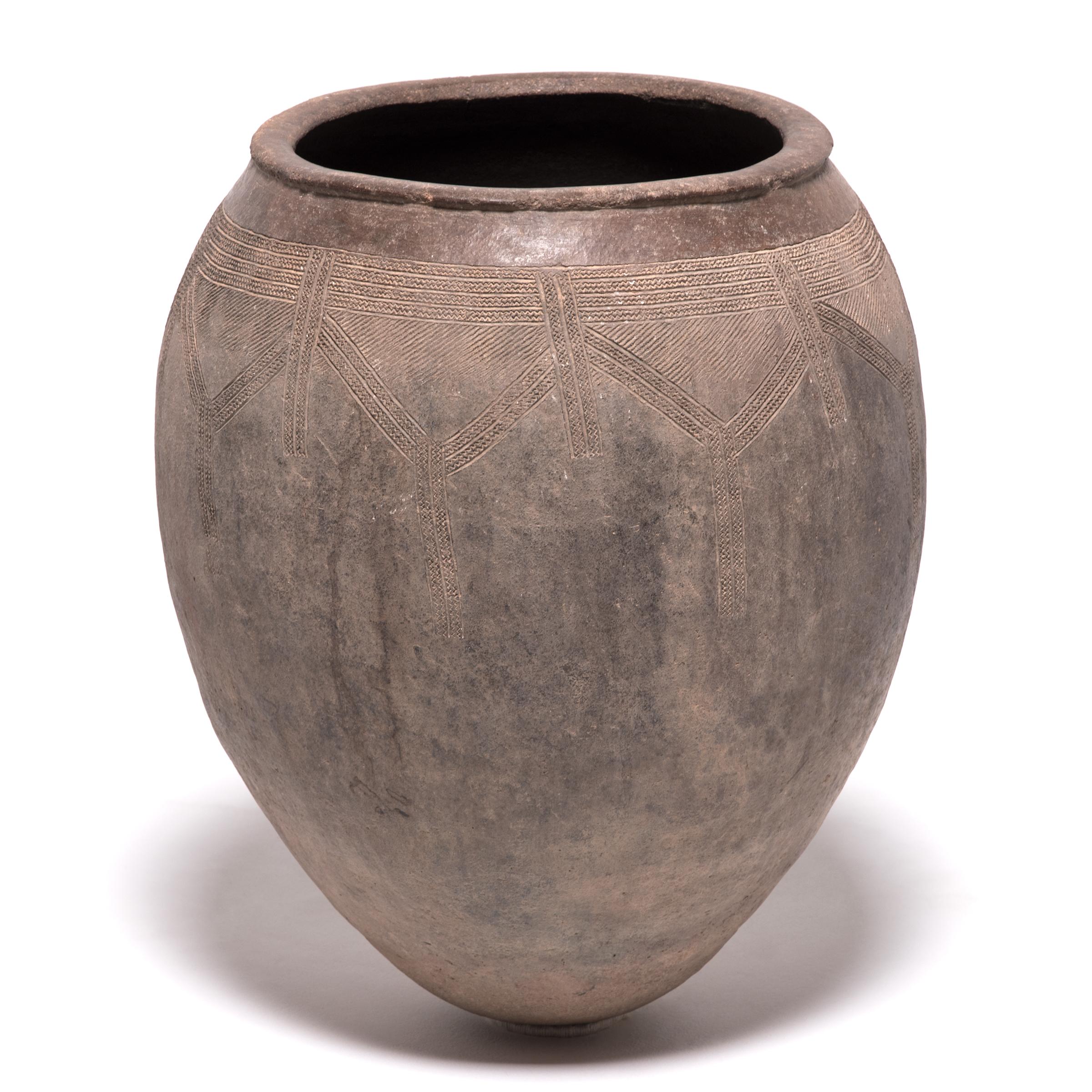 Ovoid pots were an elegant storage solution in African tribal life. This beautifully balanced example is attributed to the Toussian people of Western Burkina Faso. Masterfully made to protect its contents from the elements, pots such as this one