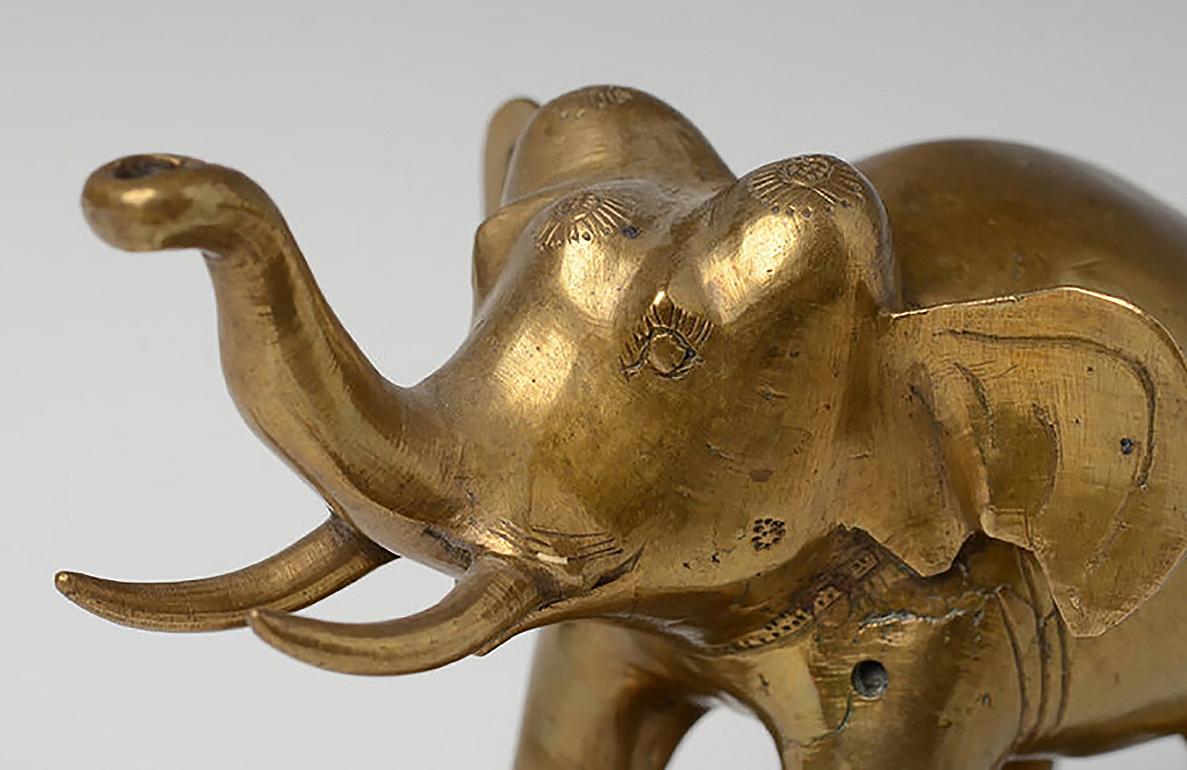 Burmese bronze standing elephant with stand.

Age: Burma, Early 20th Century
Size: Height 15.5 C.M. / Width 11.5 C.M. / Length 18 C.M. (size excluding stand)
Condition: Nice condition overall (some expected degradation due to its age). 

100%