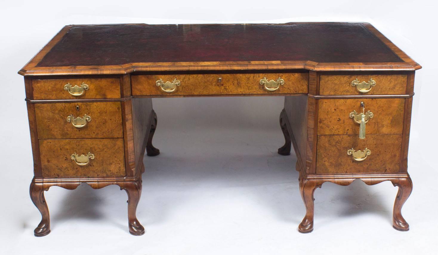 This is a superb antique bur walnut pedestal partners desk in Queen Ann style, circa 1900. 

The desk is made with beautiful burr walnut which has a highly decorative grain. It is fitted to one side with one long and two short frieze drawers and