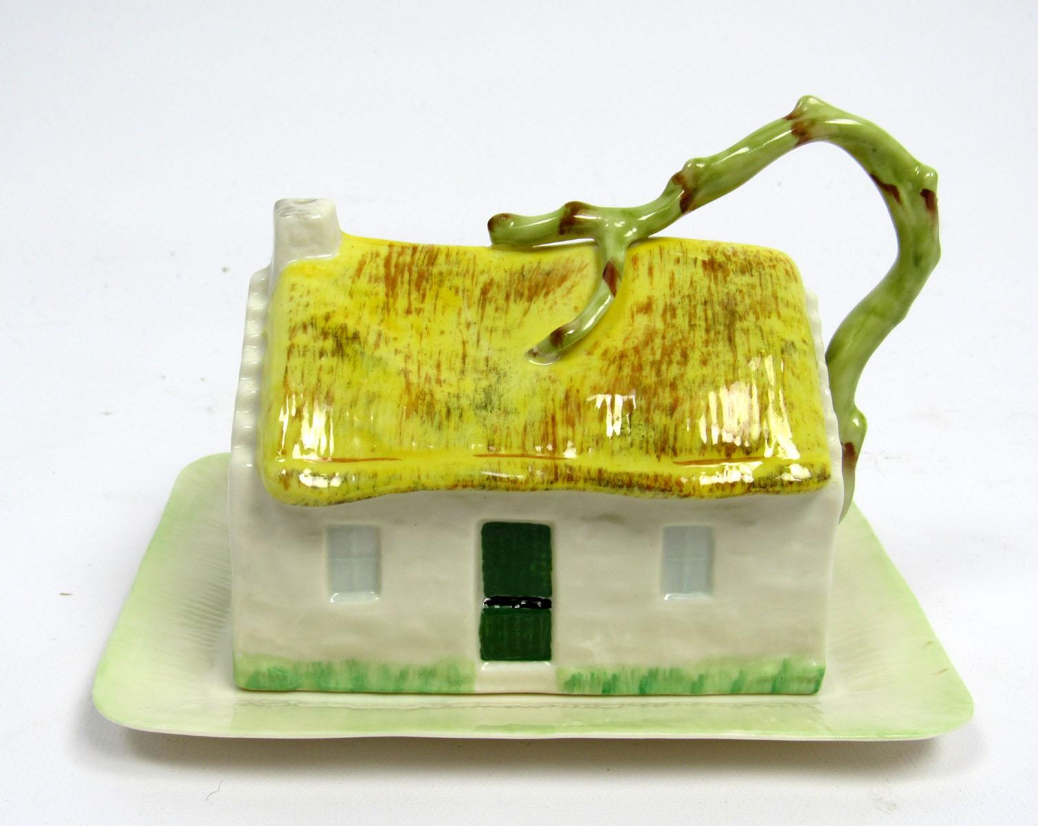Early 20th century porcelain butter dish in the form of a cottage by Belleek of Ireland.