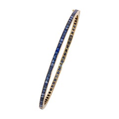 Early 20th Century Calibré Sapphire and Gold Bangle Bracelet