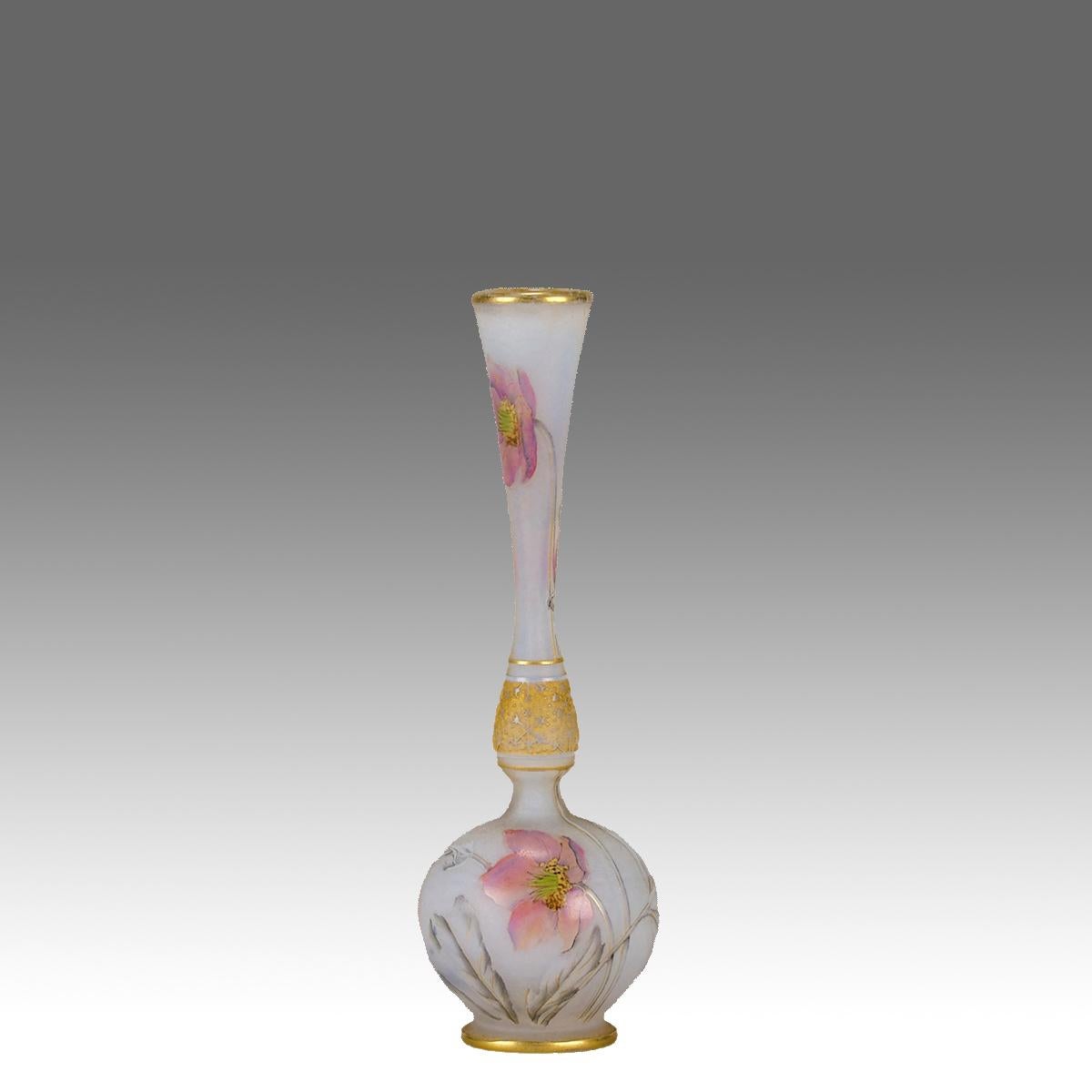 An intricate cameo glass vase etched and enamelled with pink hellebore floral decoration against a white field highlighted with gilding. The vase exhibiting very fine colour and detail, signed Daum Nancy with the Cross of Lorraine.

ADDITIONAL