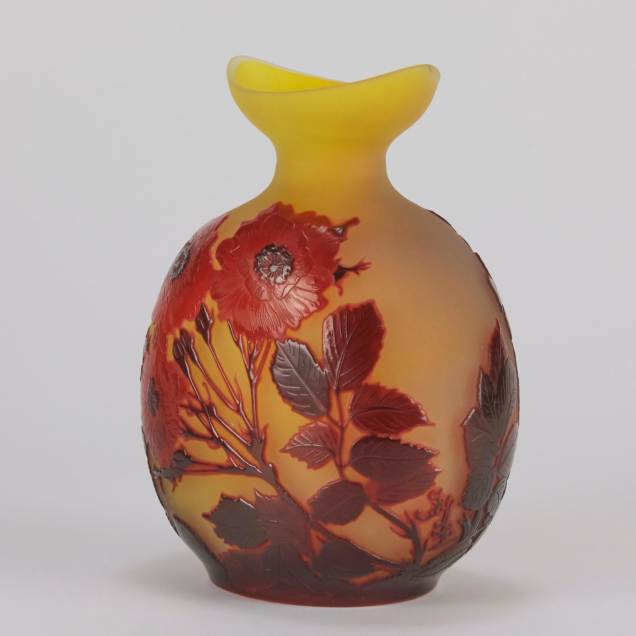 Un beau vase en verre camée du début du 20e siècle, taillé à l'acide et gravé d'une décoration florale rouge profond sur fond jaune. Avec un croissant de lune à l'ouverture du vase. Présentant de très beaux détails de surface finis à la main et des