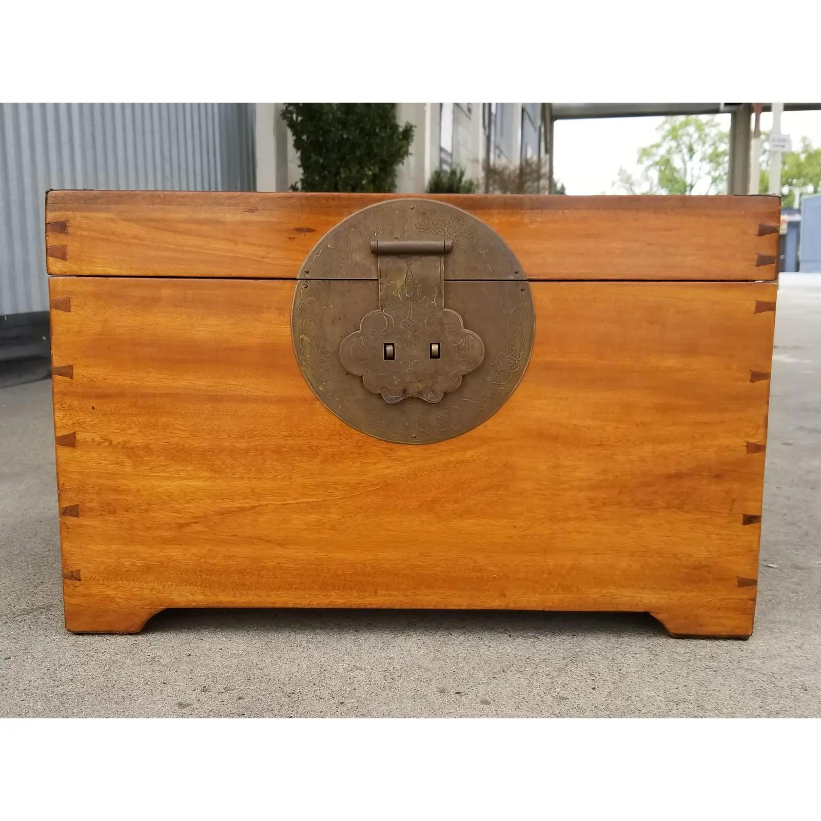 Solid camphor wood trunk with brass detail, hinges and clasp. Figured wood grain with a beautiful, warm glow to finish. Hand dovetail construction, early 20th century. Unusual, smaller size would make an excellent end table with storage capabilities.