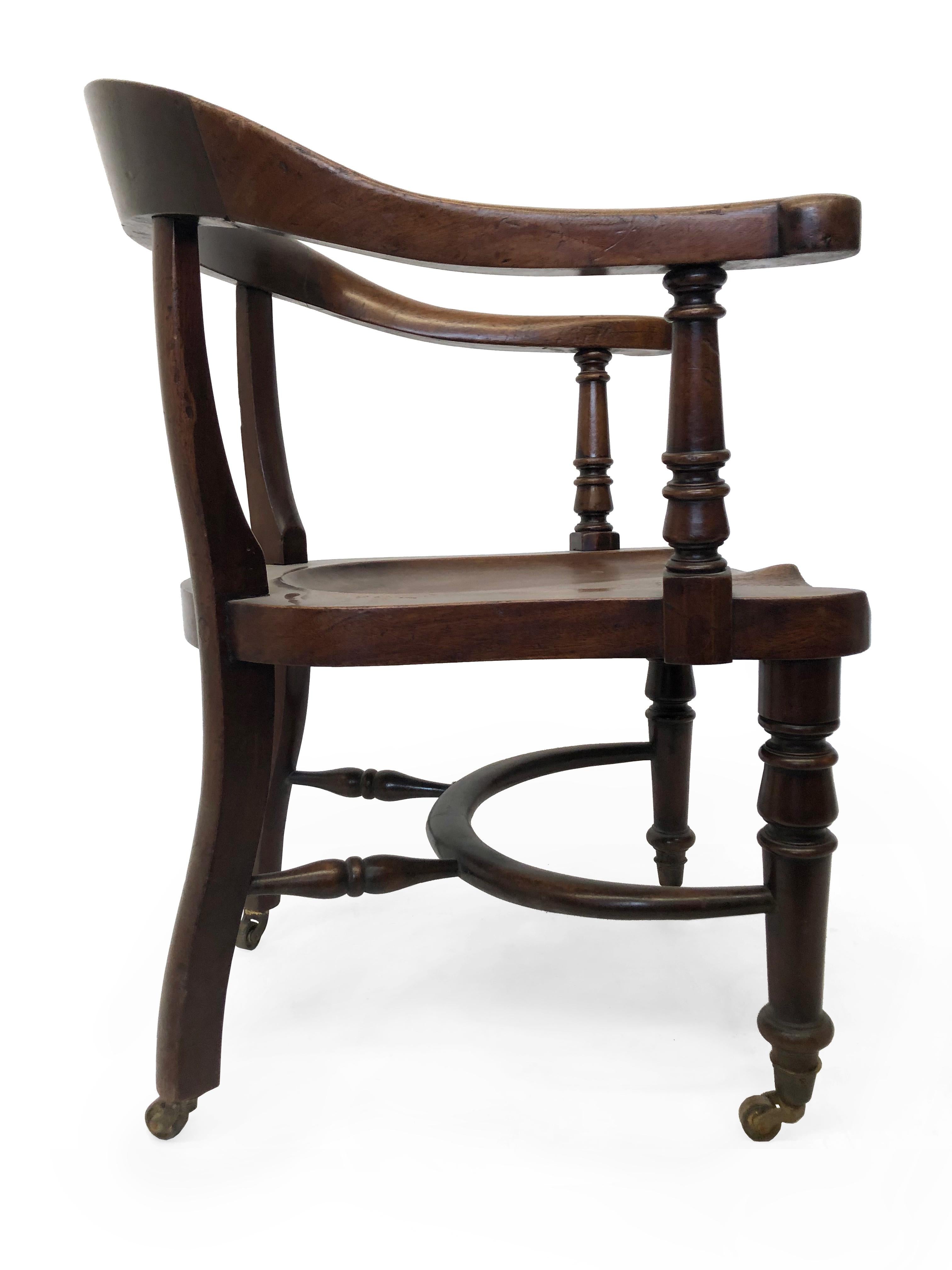 Solid wood captain's chair with molded seat and back. American, early 20th century. Brass casters. Simple early industrial design executed in walnut.

Property from esteemed interior designer Juan Montoya. Juan Montoya is one of the most acclaimed