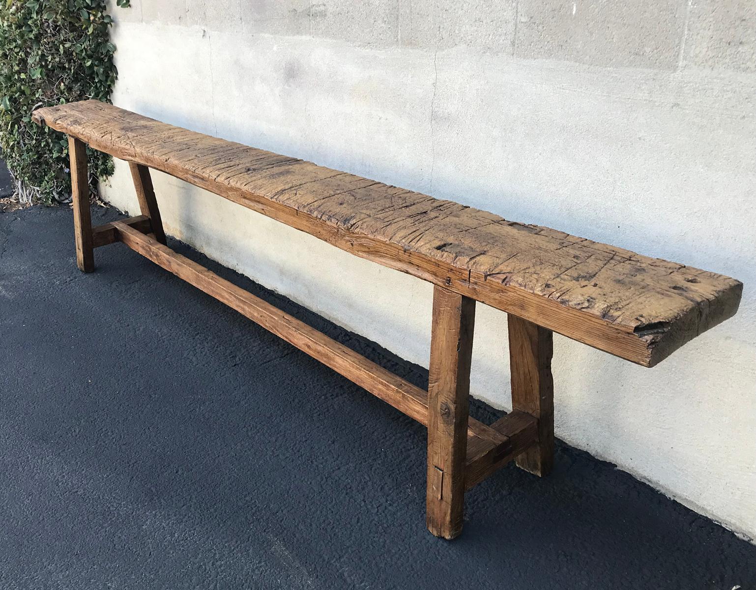 Early 20th century carpenter's bench from the highlands of Guatemala. It shows years of use and has a lovely, naturally worn patina. Saw marks. Smooth to the touch, beautiful color. Perfect piece behind a sofa or underneath artwork.